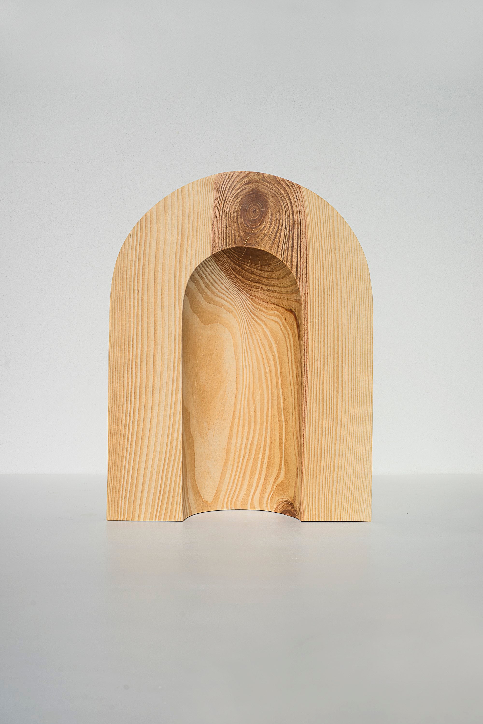 Sculptures — front view of handcrafted light wood arch design