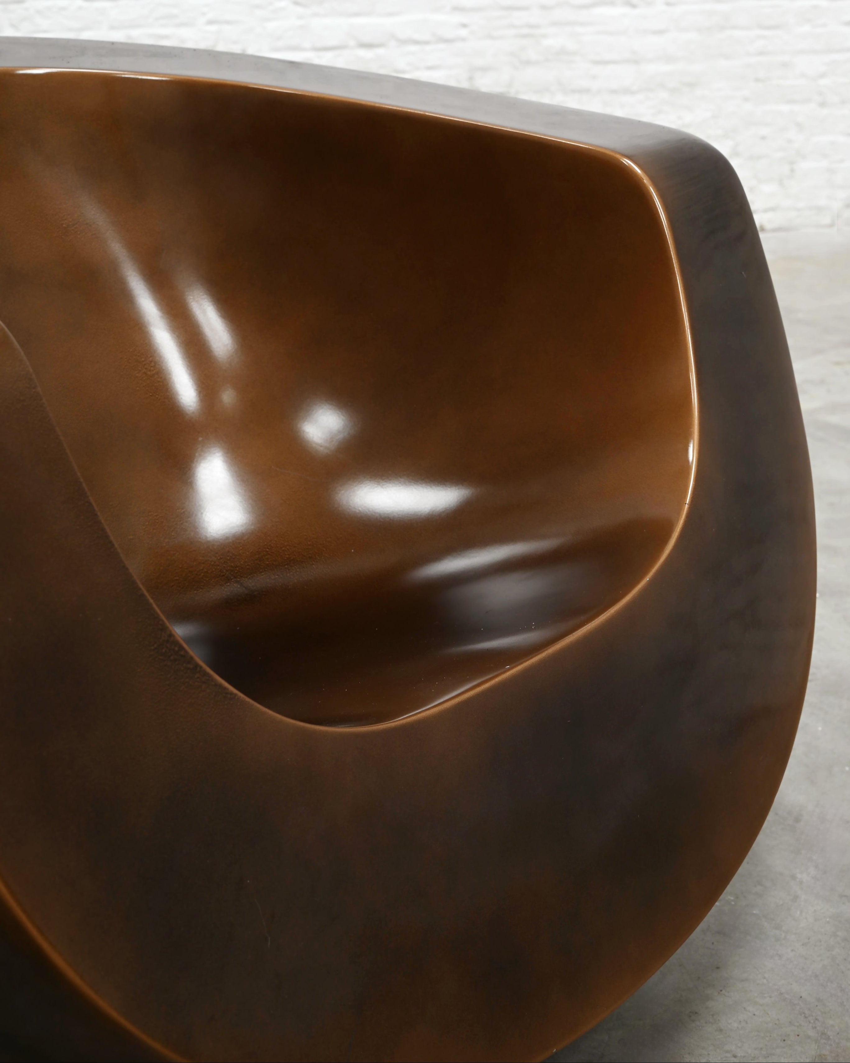 Close-up detail of brown fiberglass Moon chair sculptural form