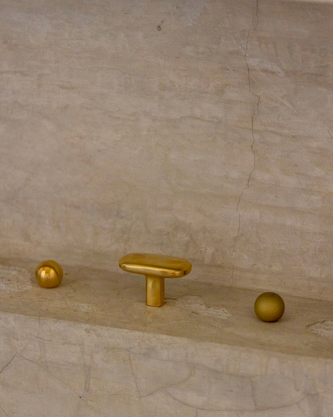 OVAL Cabinet Knob/Wall Hook — close-up on textured brass knobs
