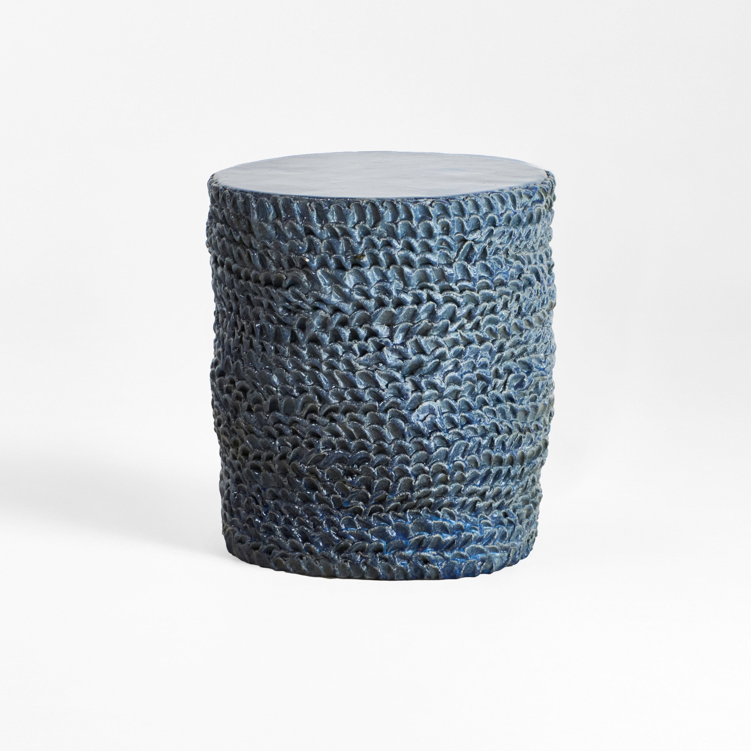 Casa Ceramic Side Table — textured blue ceramic surface in studio setting