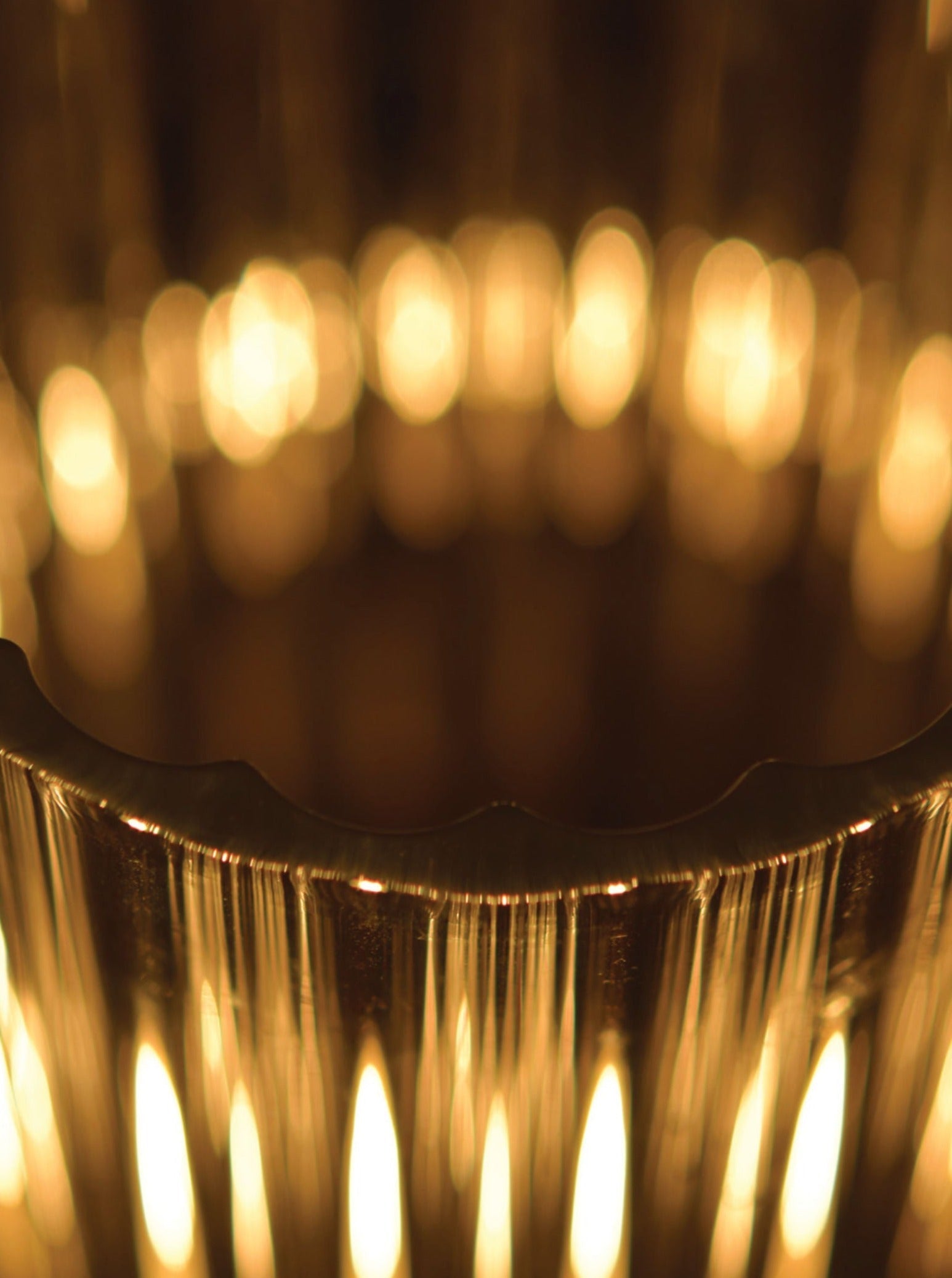 Magda Wall Light — close-up of textured metallic surface with warm glow