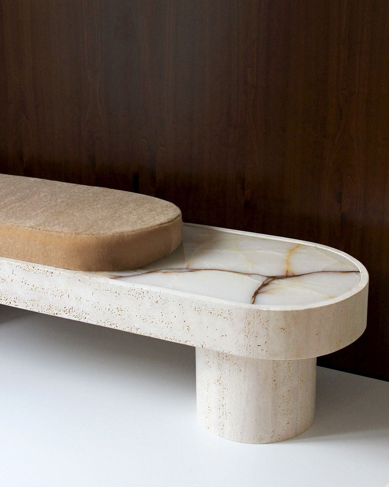 Noto Bench — close-up of beige upholstered seat on marble base