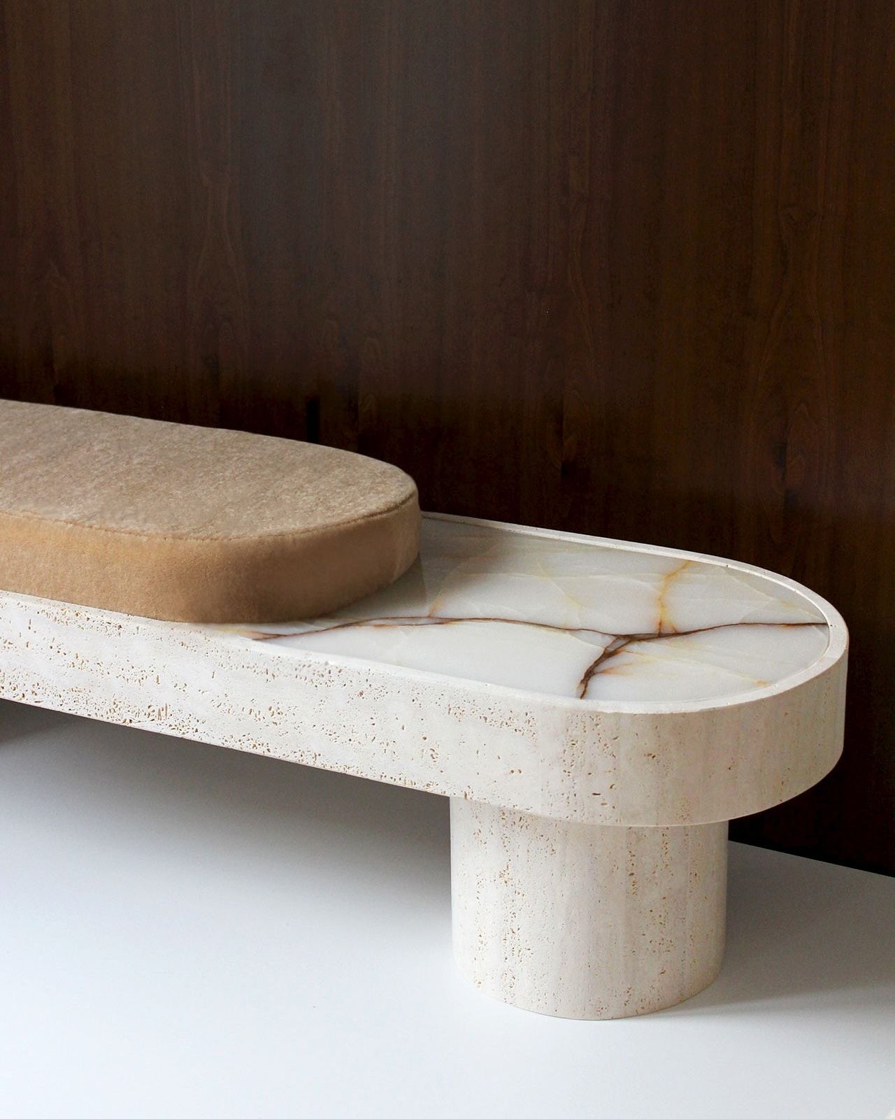 Noto Bench — close-up of beige upholstered seat on marble base