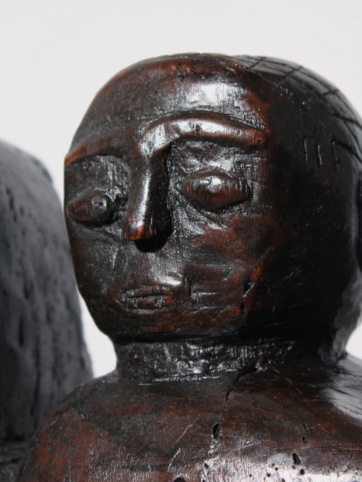 Large African Ashanti Figural Stool — close-up of dark wood face detail