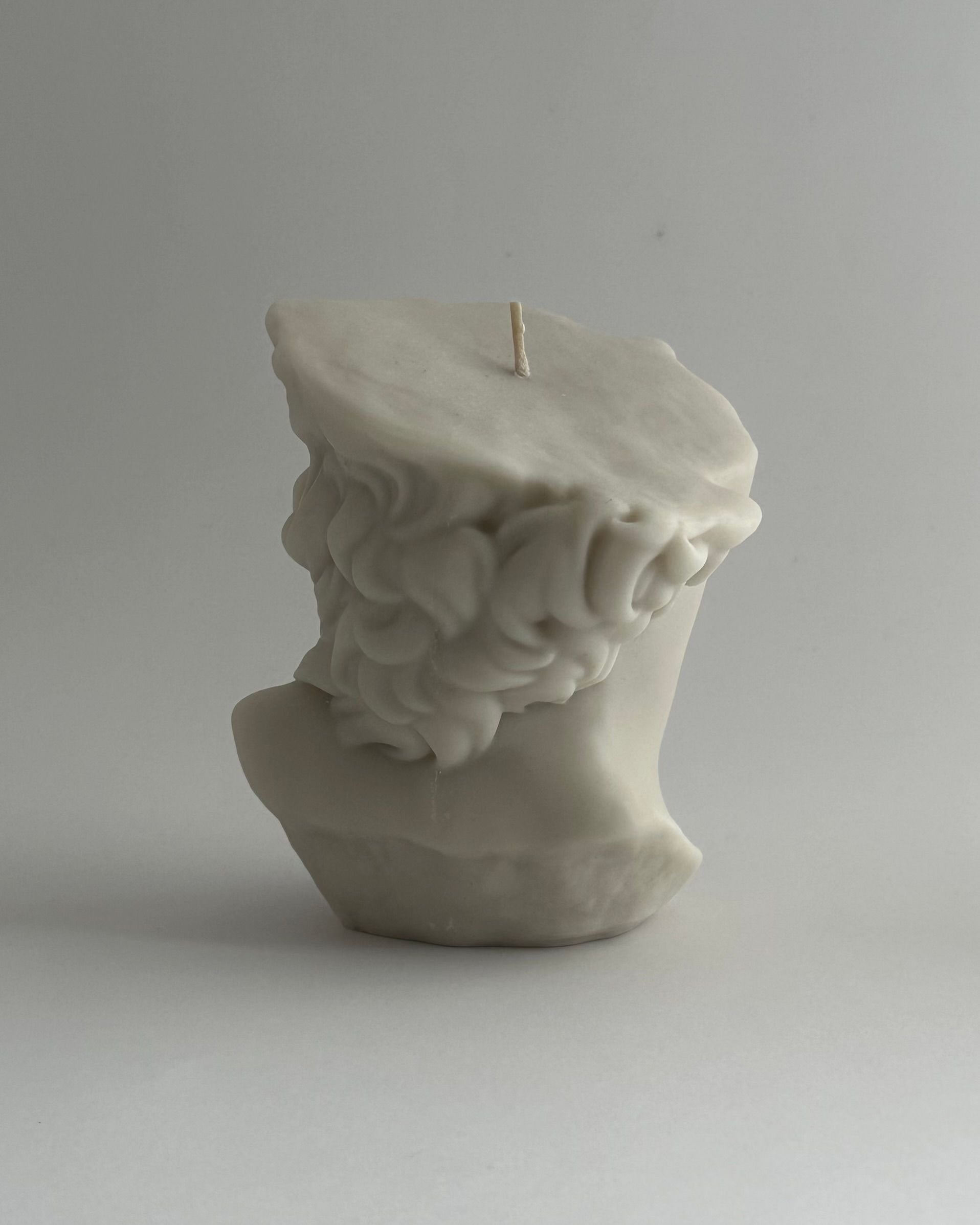 THE GREAT' candle — side angle showing creamy white sculptural design