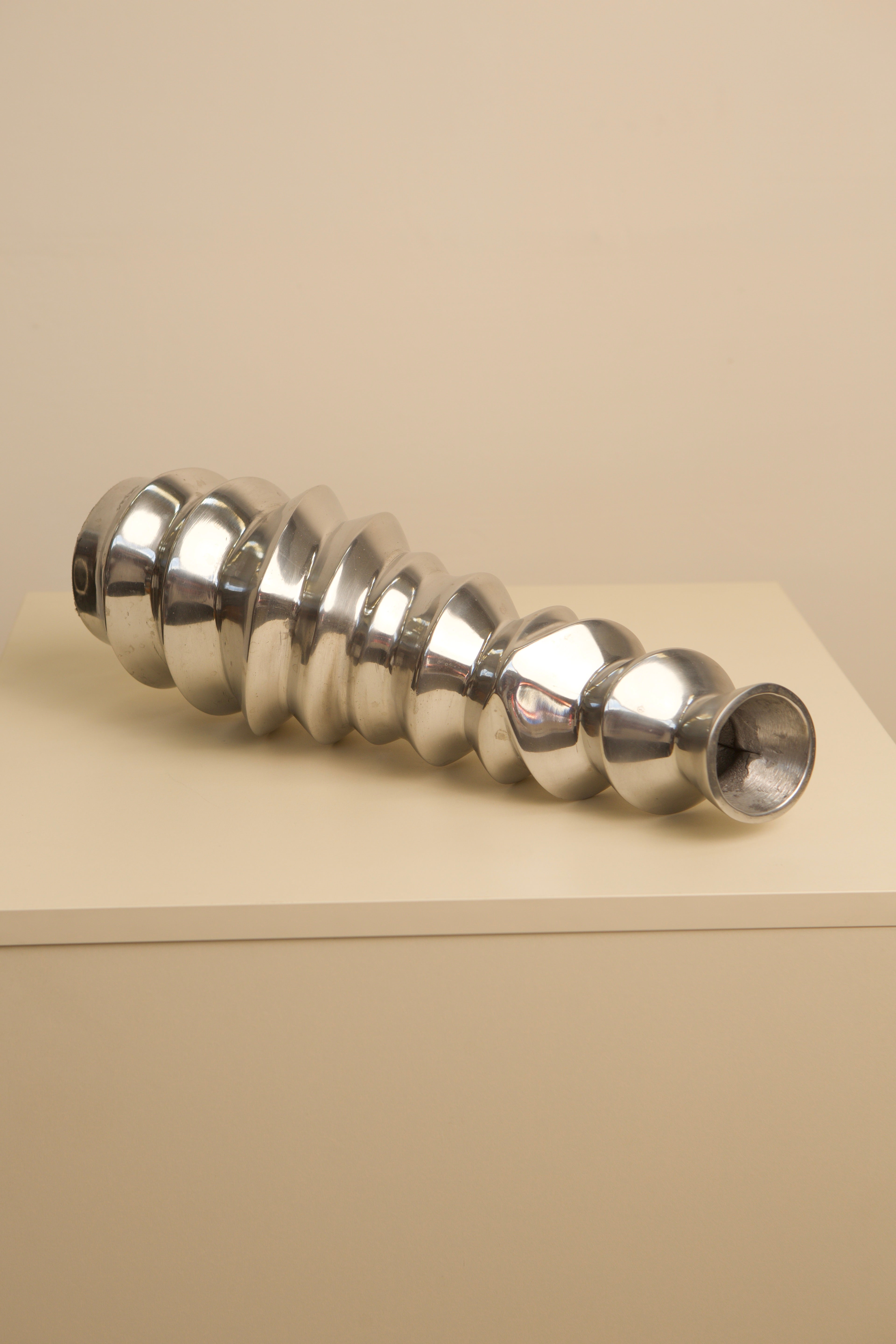 Large Italian aluminum escalier vase showing sculptural ridged form