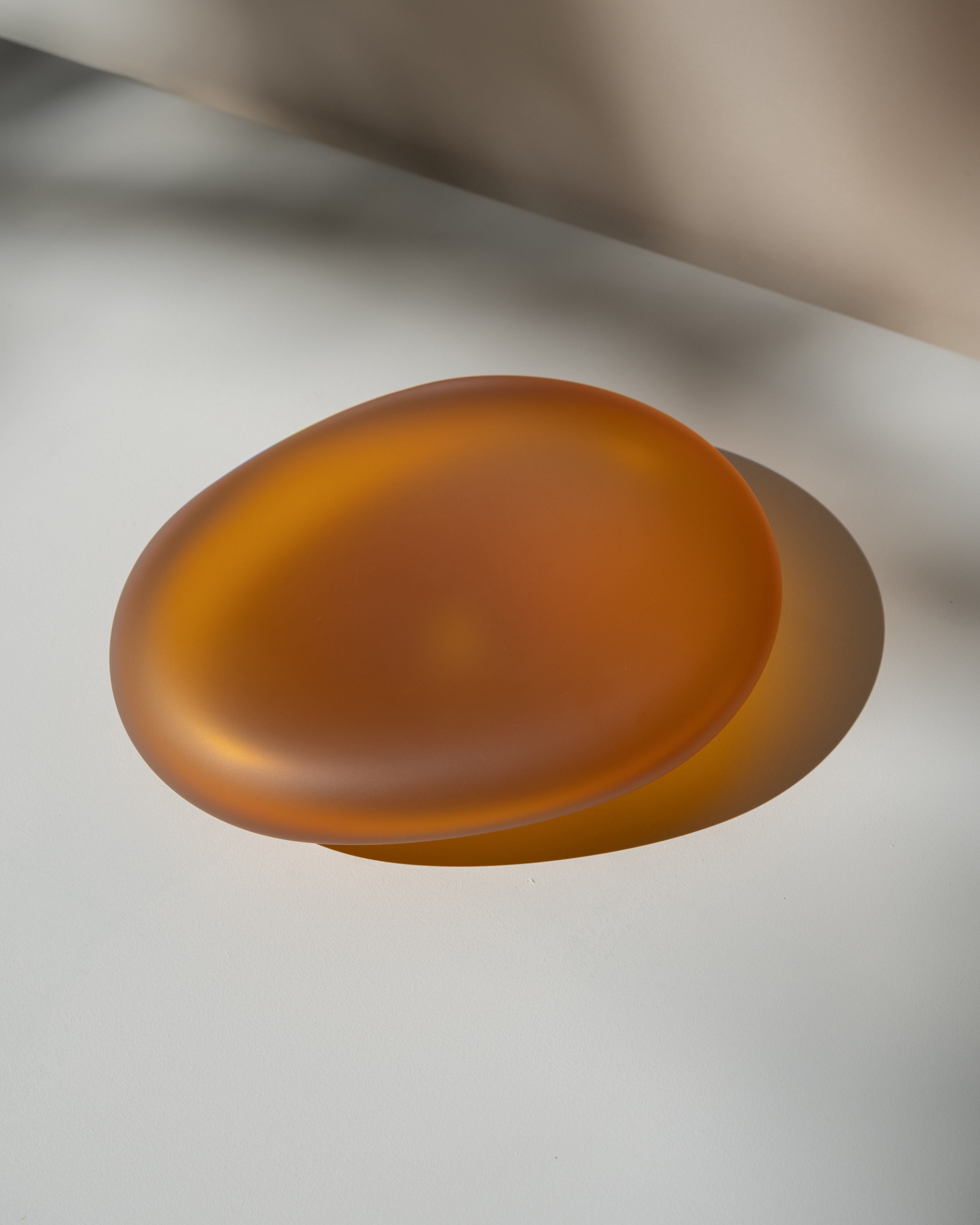 Glass Sculptures SEAGLASS | color deep amber — side angle on light surface