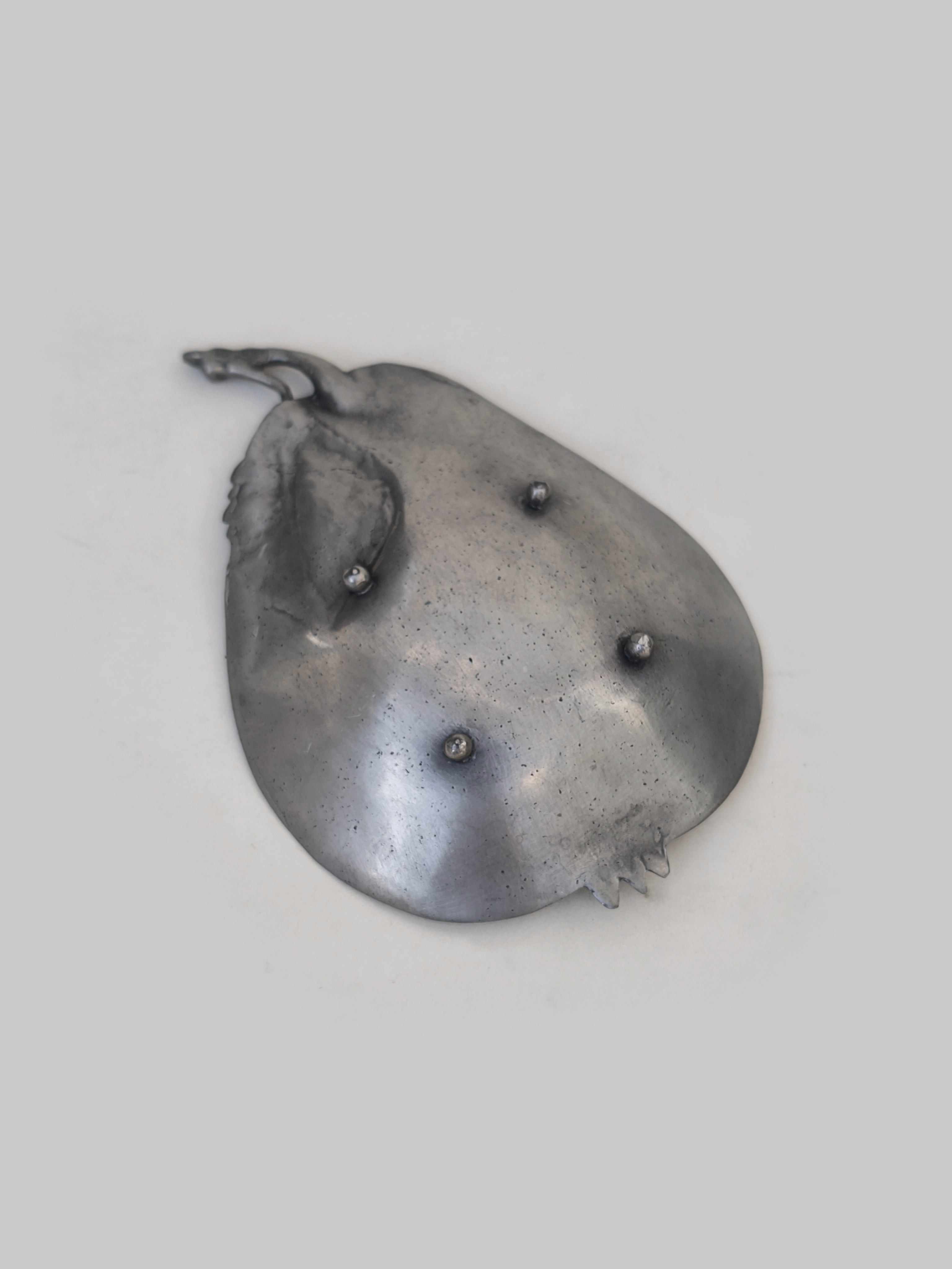 Pear pewter vide poche — side angle showing textured surface and shape