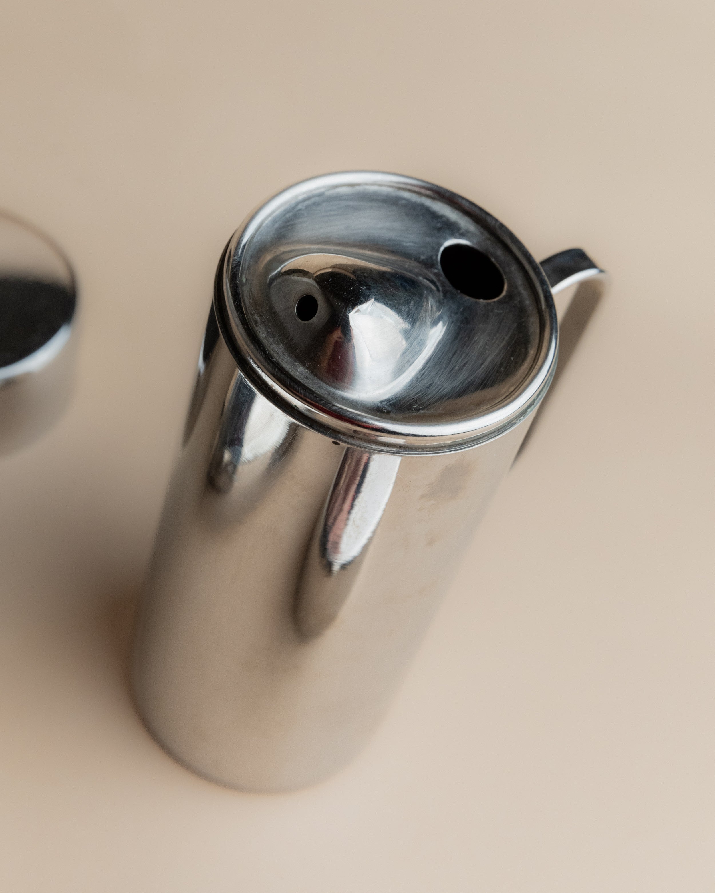 Close-up detail of stainless steel oil vinegar set lid and spout