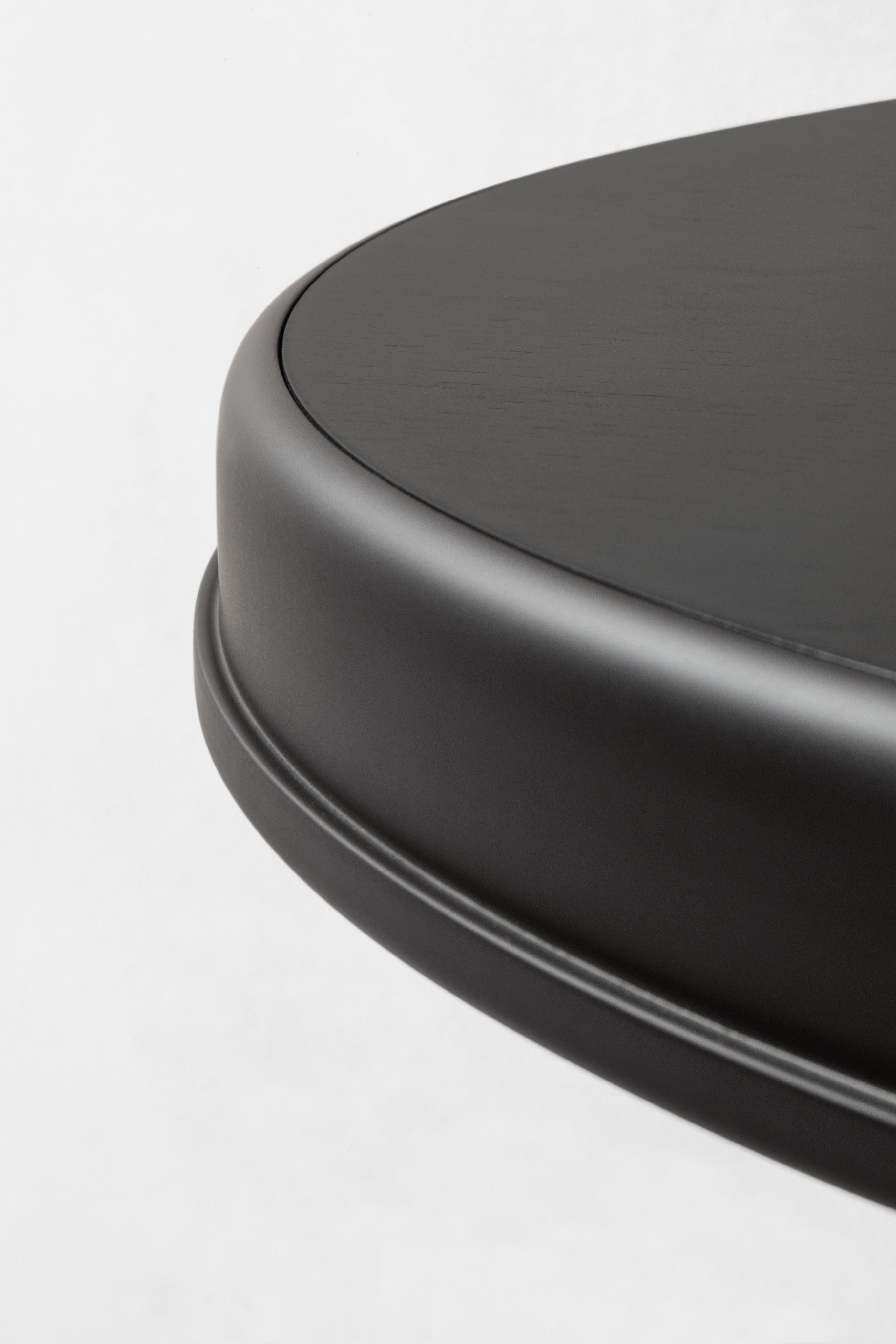 Round table curved edge detail in dark brushed finish