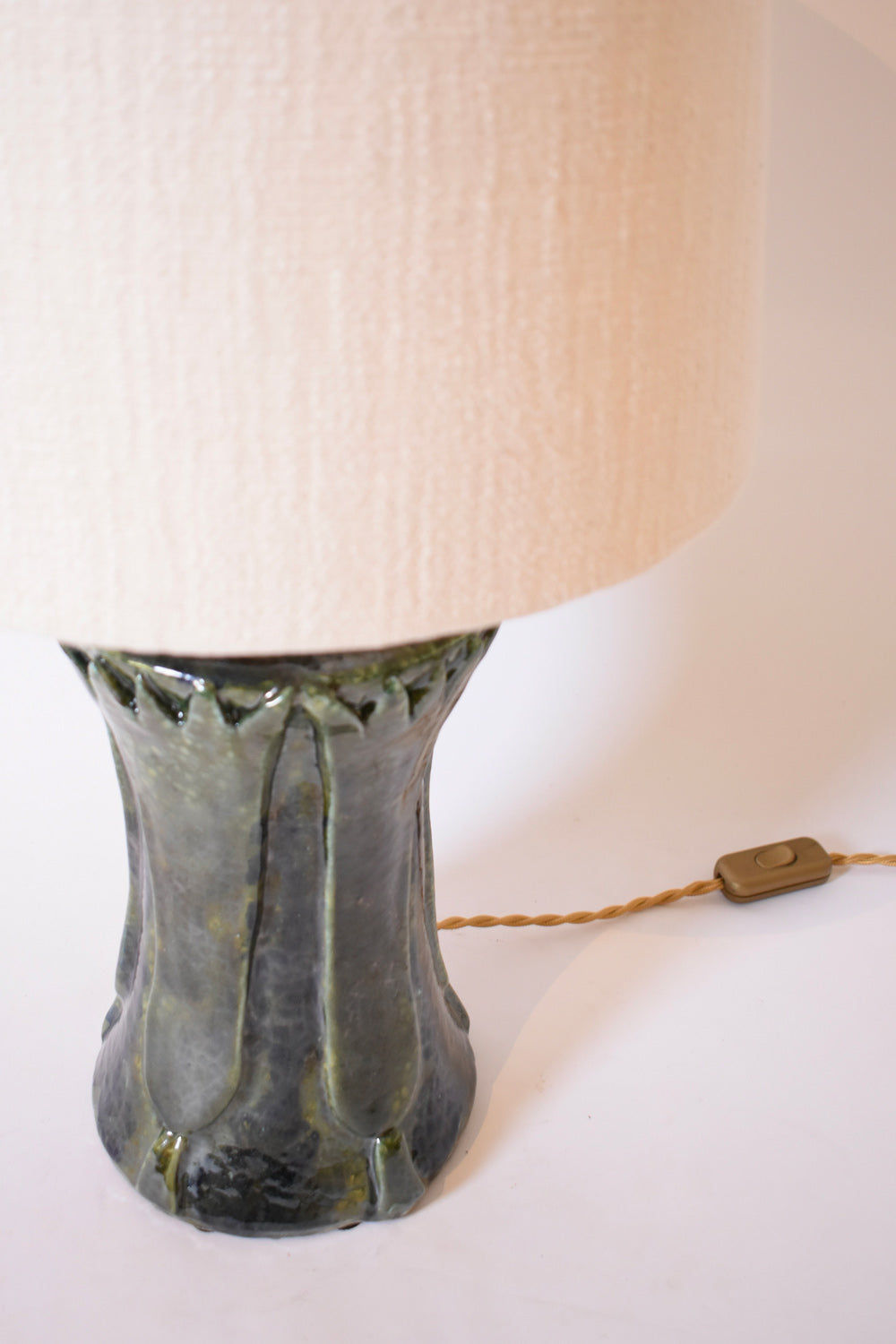 The "Kasaï" Blue Green Papyrus Ceramic Lamp by Barracuda Interiors features a textured base, light beige fabric shade, twisted brown cord, and a rectangular inline switch.