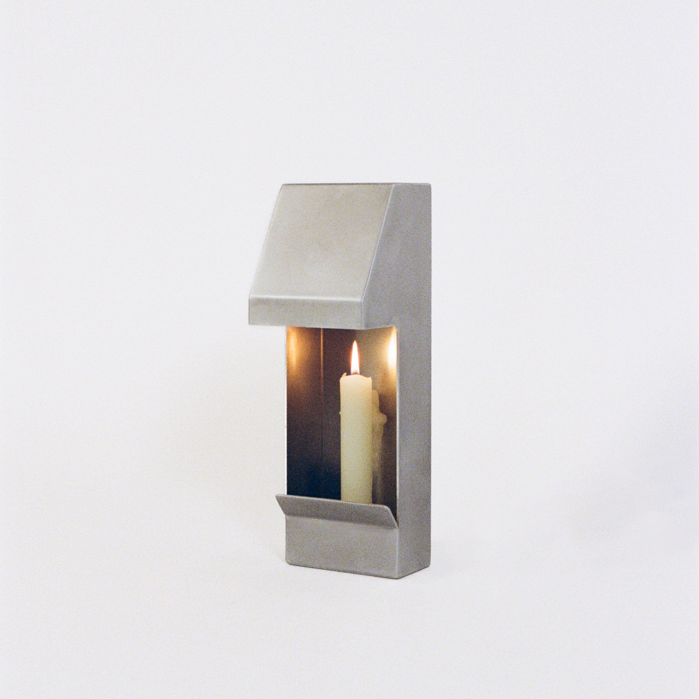 Egress Sconce Candle Holder — angled view of brushed metal finish