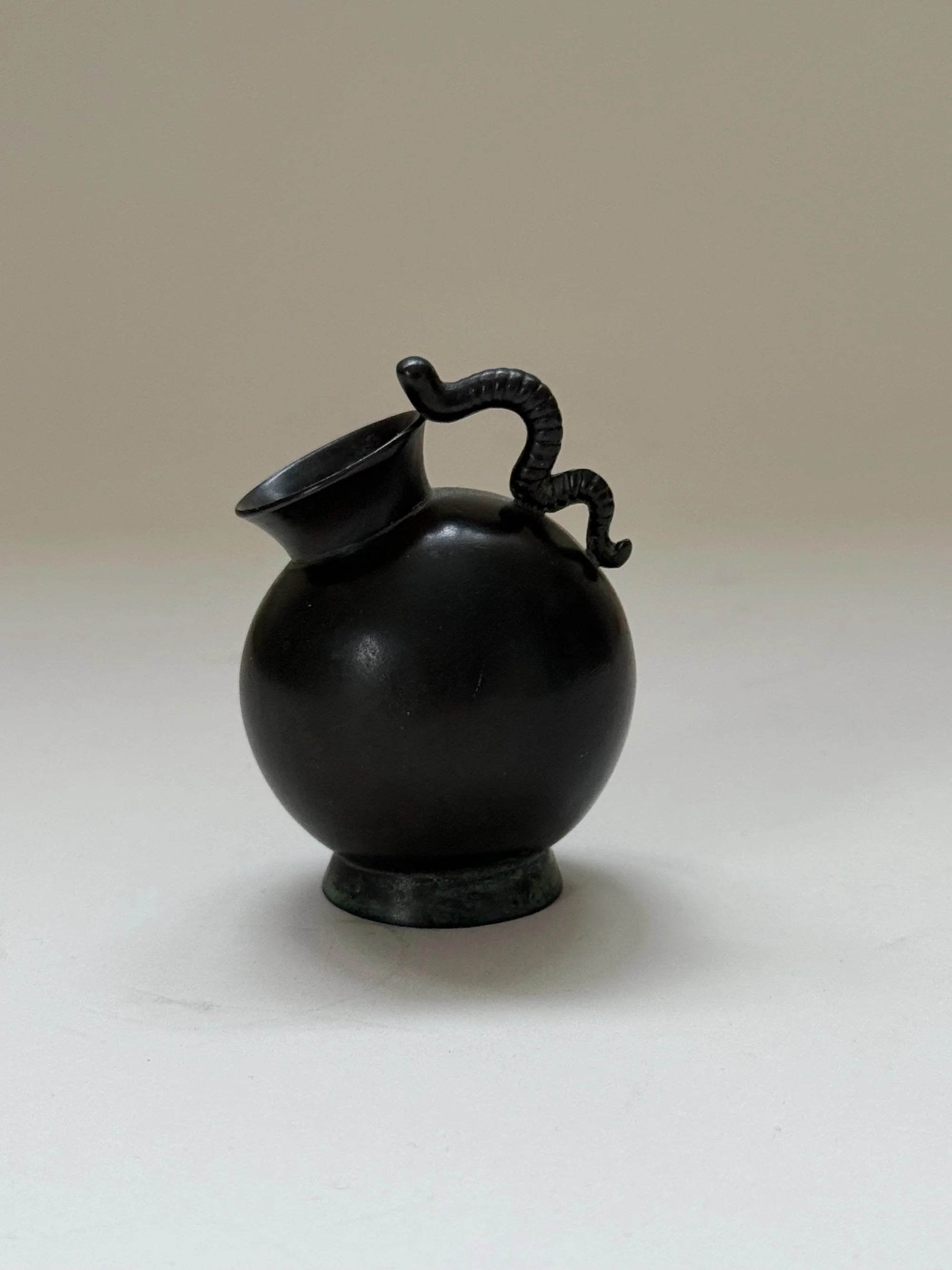 Small Just Andersen Vase in Disko Metal, Denmark, 1930s — close-up of black metal with snake handle