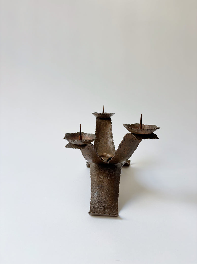 Large Metal Curved Artisan Candlestick, Poland — close-up of textured metal finish