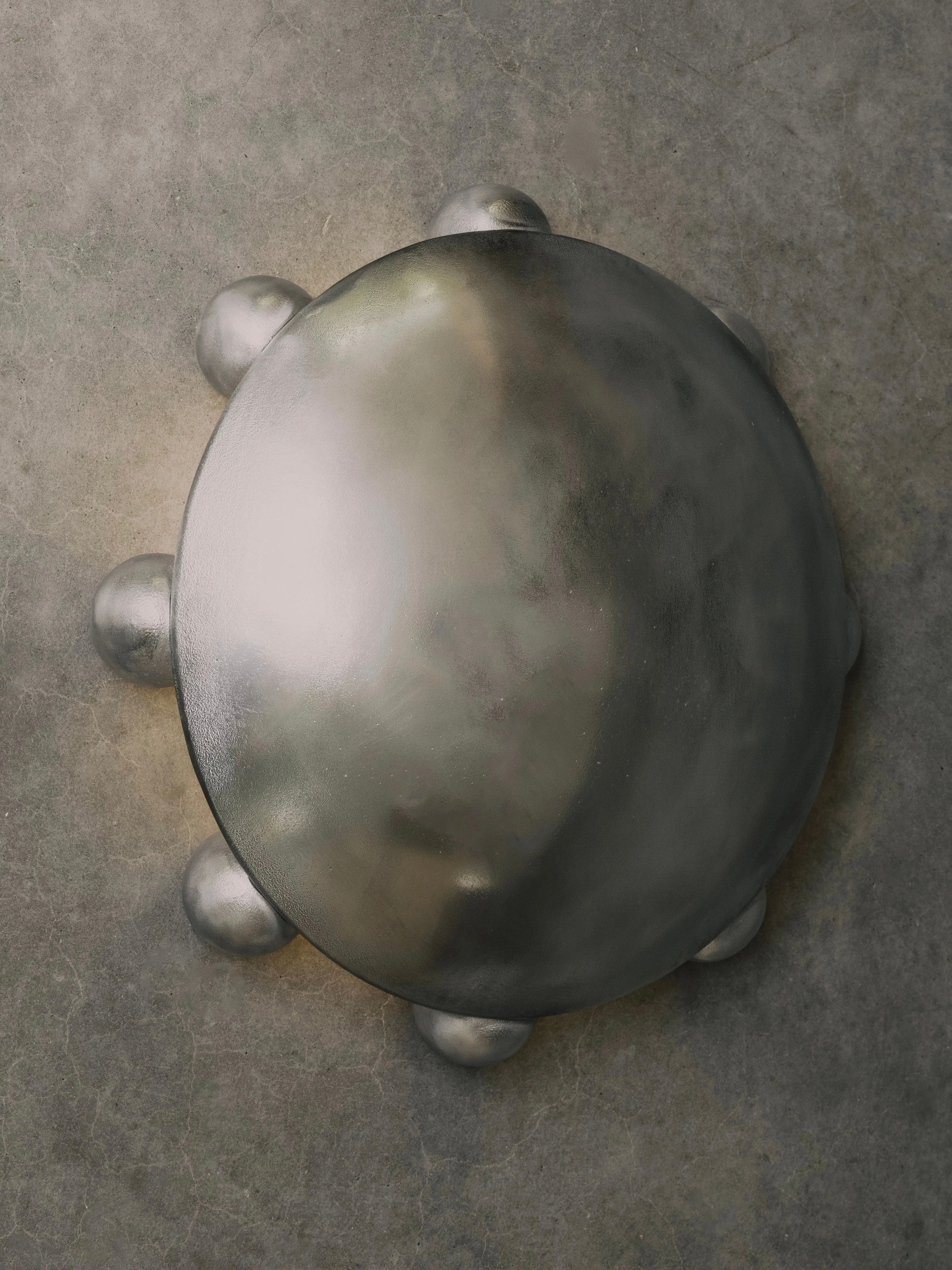 ALTER Sconce | Aluminium — top view of polished metal surface
