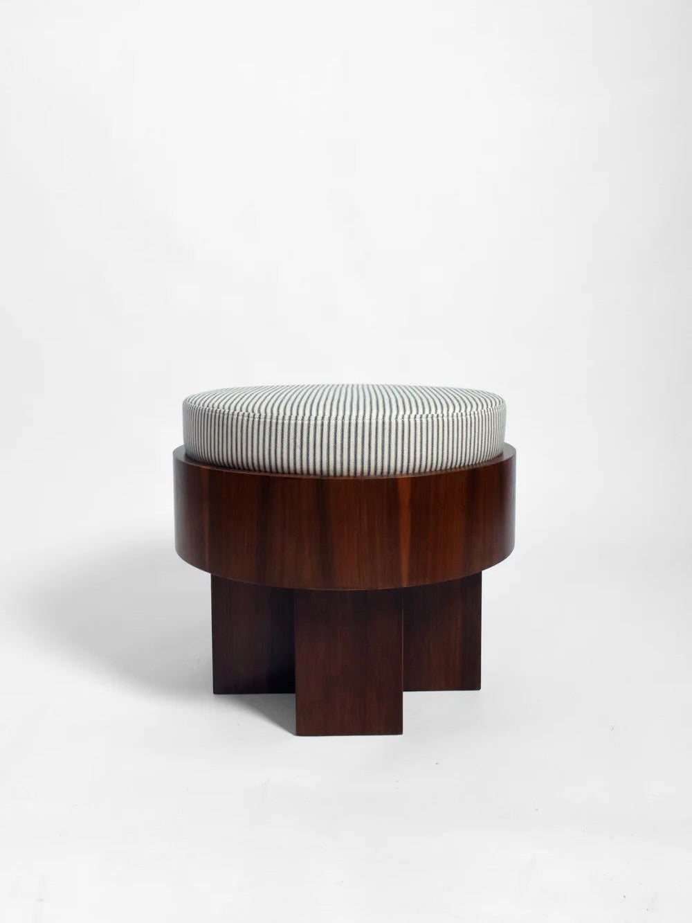 The "Vitruvio" Walnut stool by Barracuda Interiors is a round stool made in Portugal, with a dark brown base and a white cotton cushion with thin black stripes, shown against a plain white background.