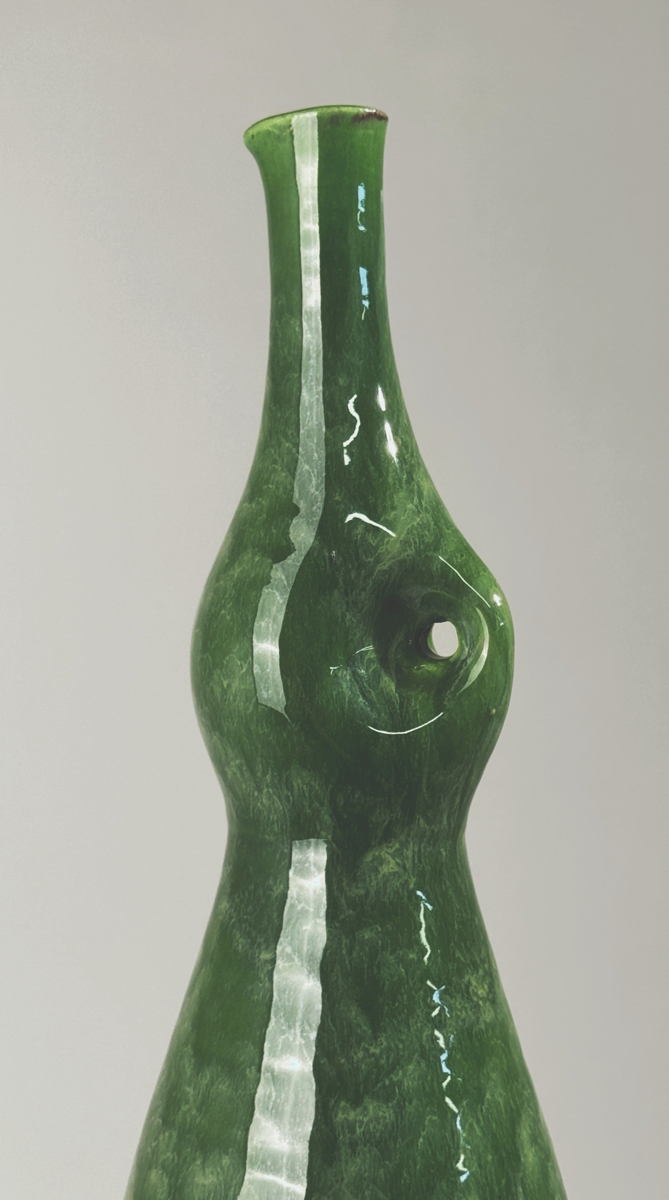 Green glazed ceramic bottle vase showing pinched waist detail, Accolay 1960