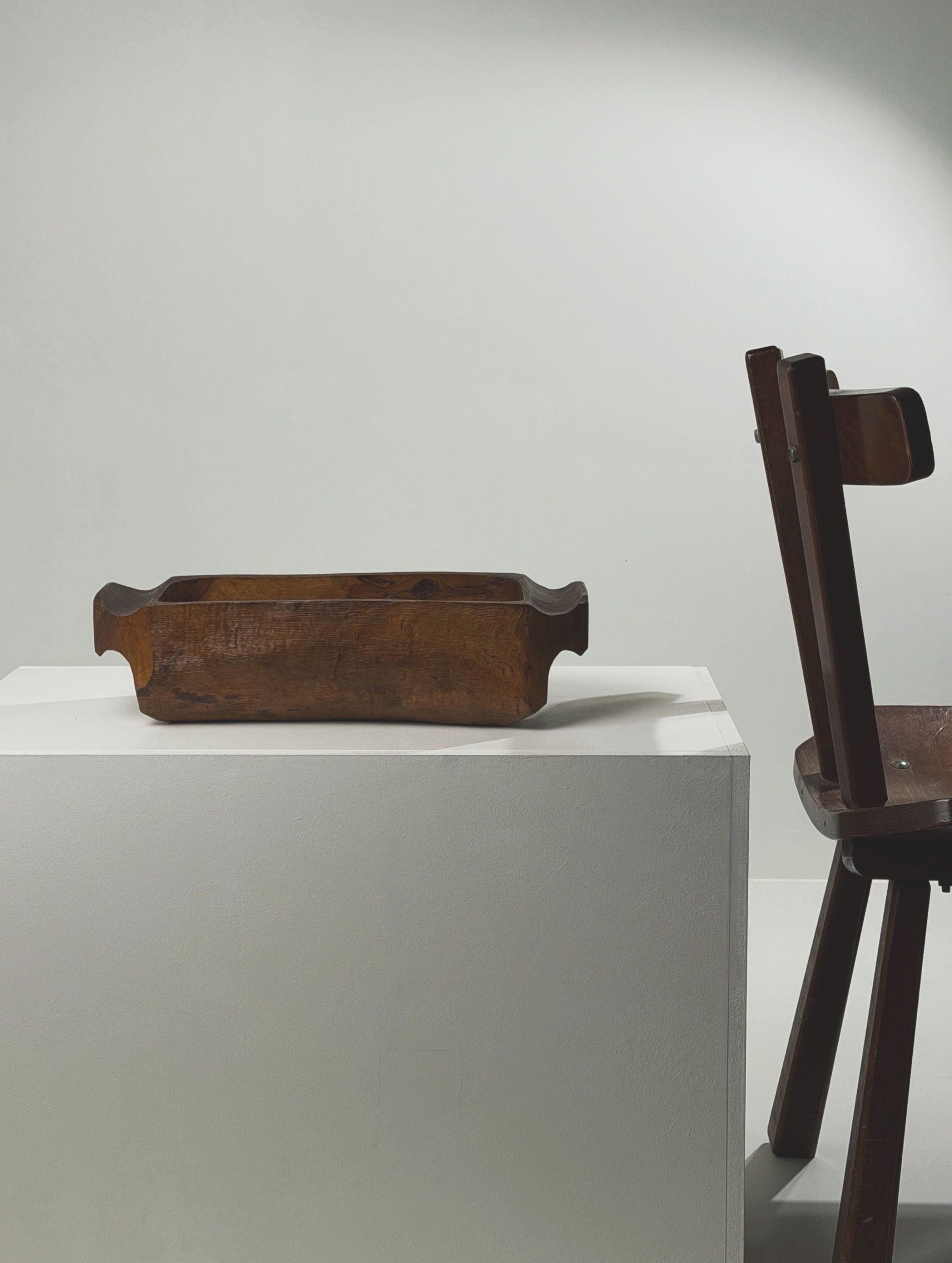 Large hand-carved wooden bowl, France, early 20th century — side view on white pedestal