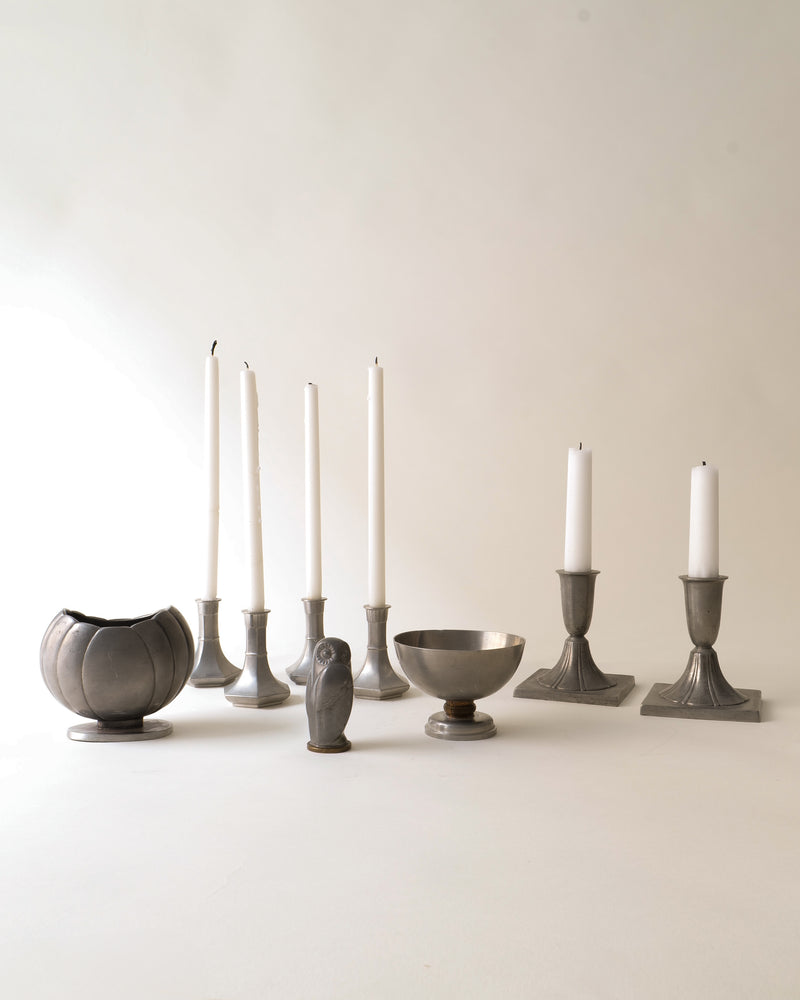 Pewter bowl styled with vintage candlesticks and ceramic vases
