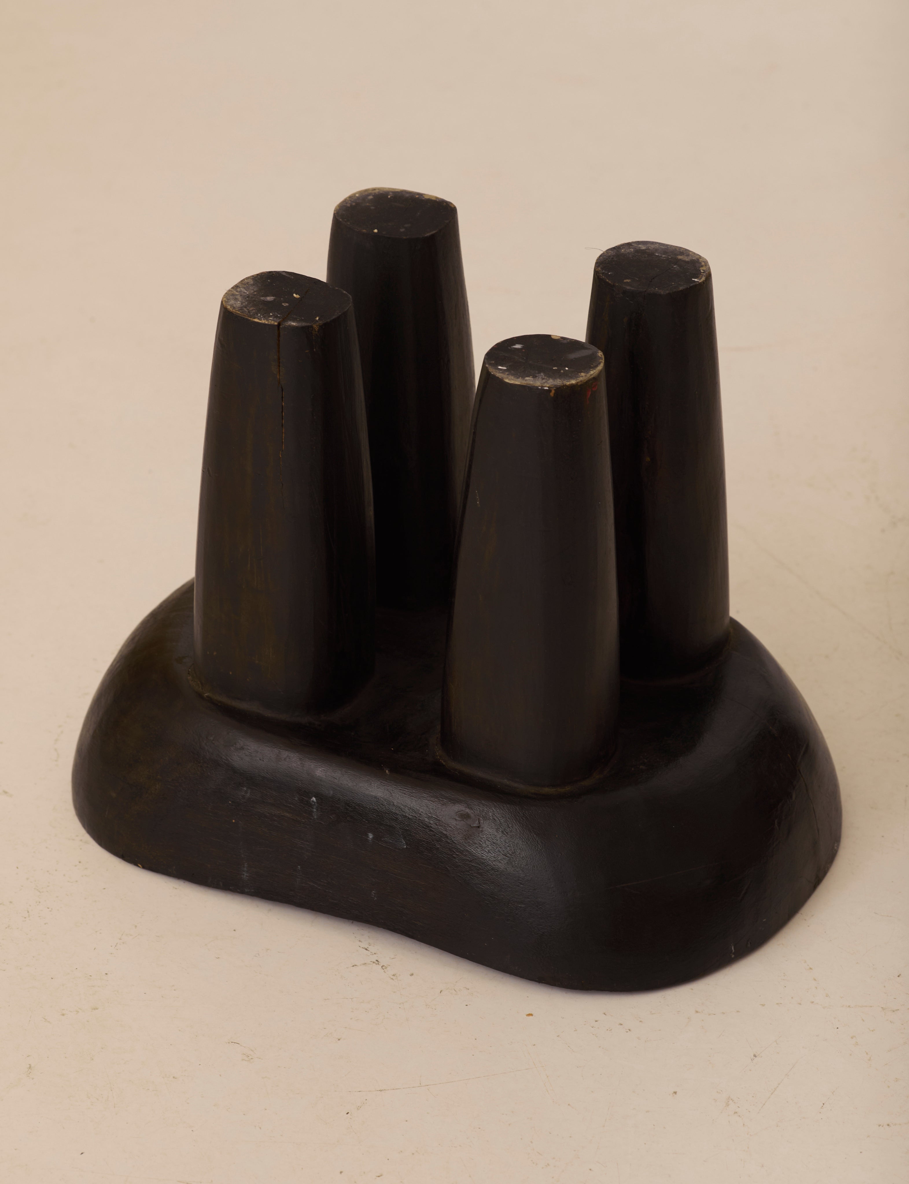 Vintage Senufo Monoxyl African Stool in Black / Wenge — angled view on neutral background