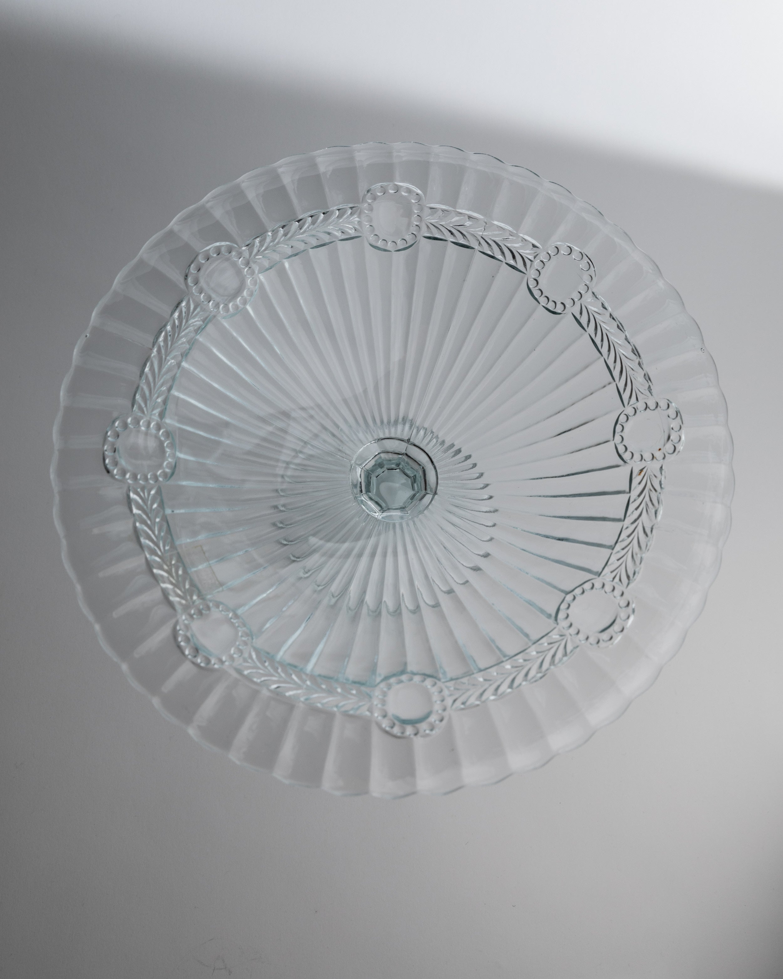 Crystal glass serving dish bottom view showing radial sunburst pattern