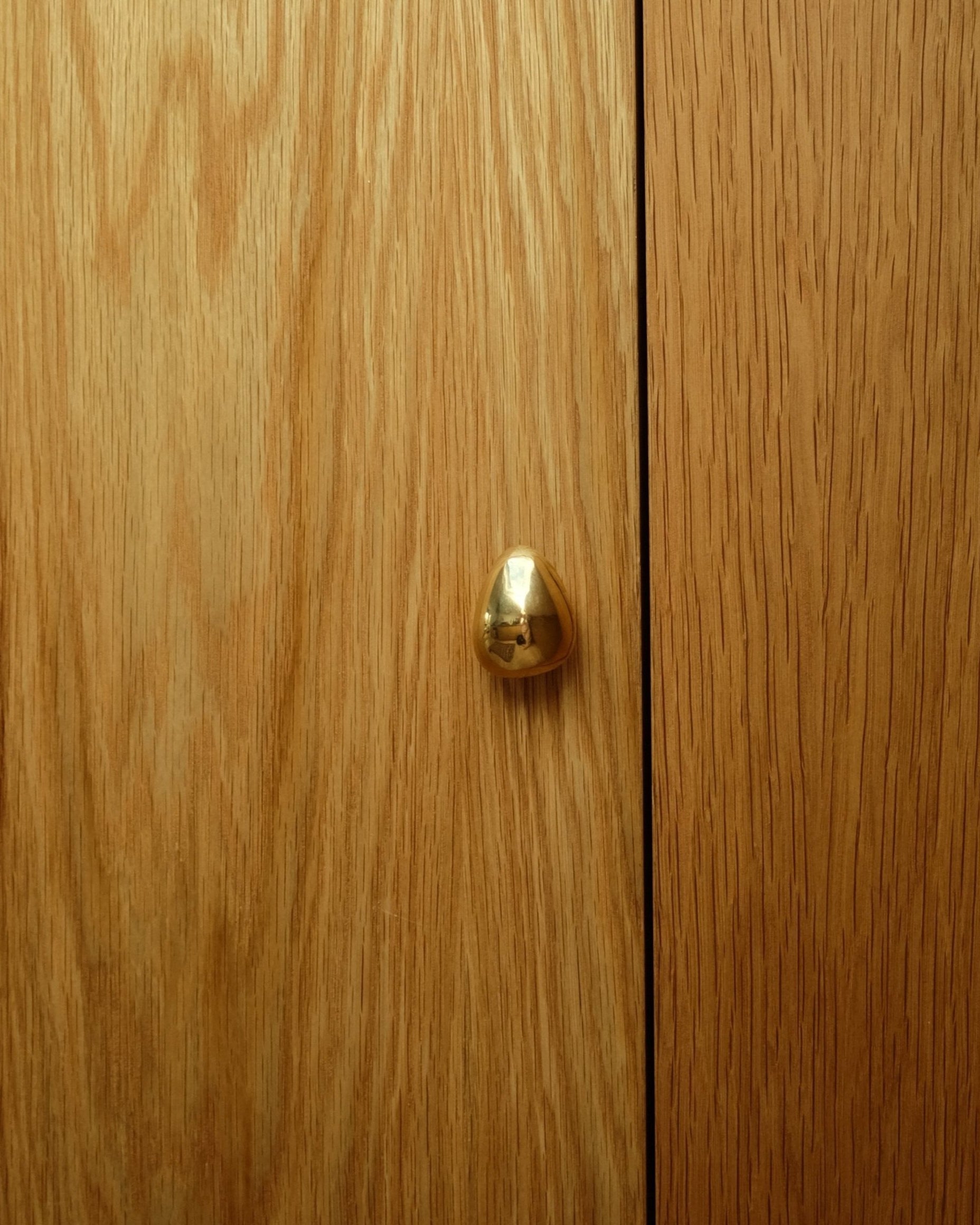 MOMI Cabinet Knob/Wall Hook Short Mini — close-up on wooden cabinet door