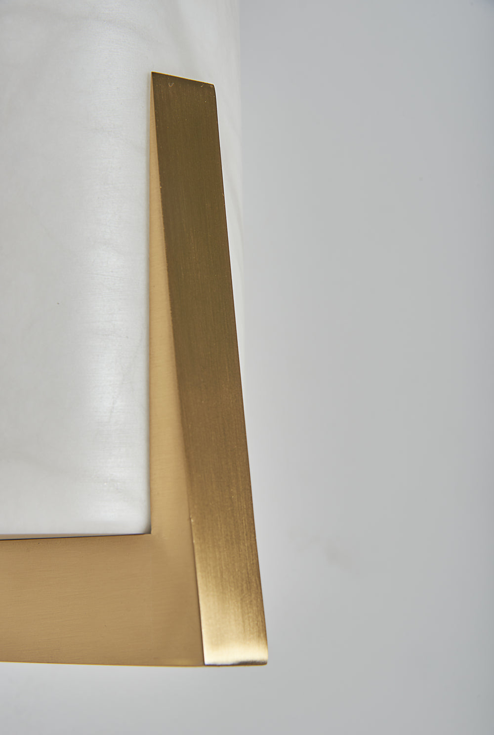 ZENO Wall Sconce in alabaster and brass — lifestyle setting