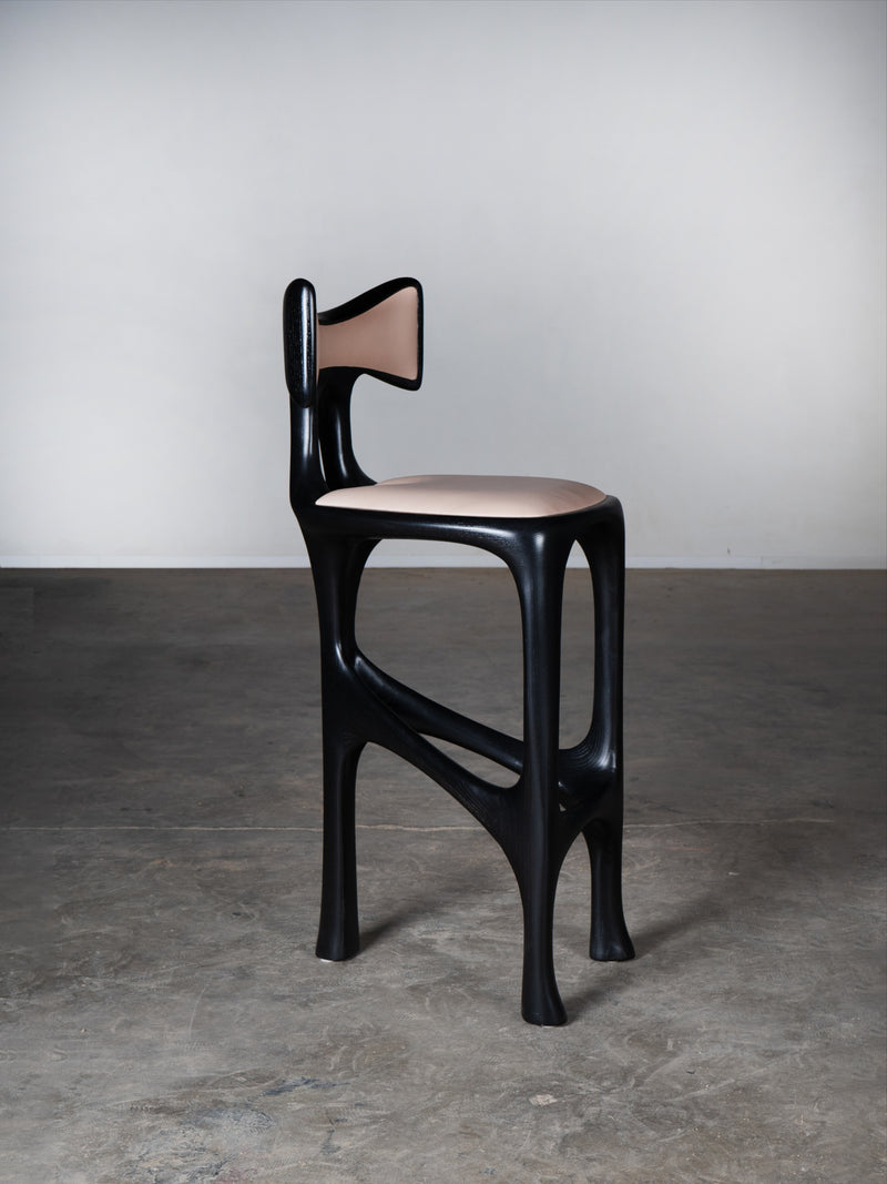 Tripa Stool in Ebony stain on Ash Wood — side view highlighting curved design