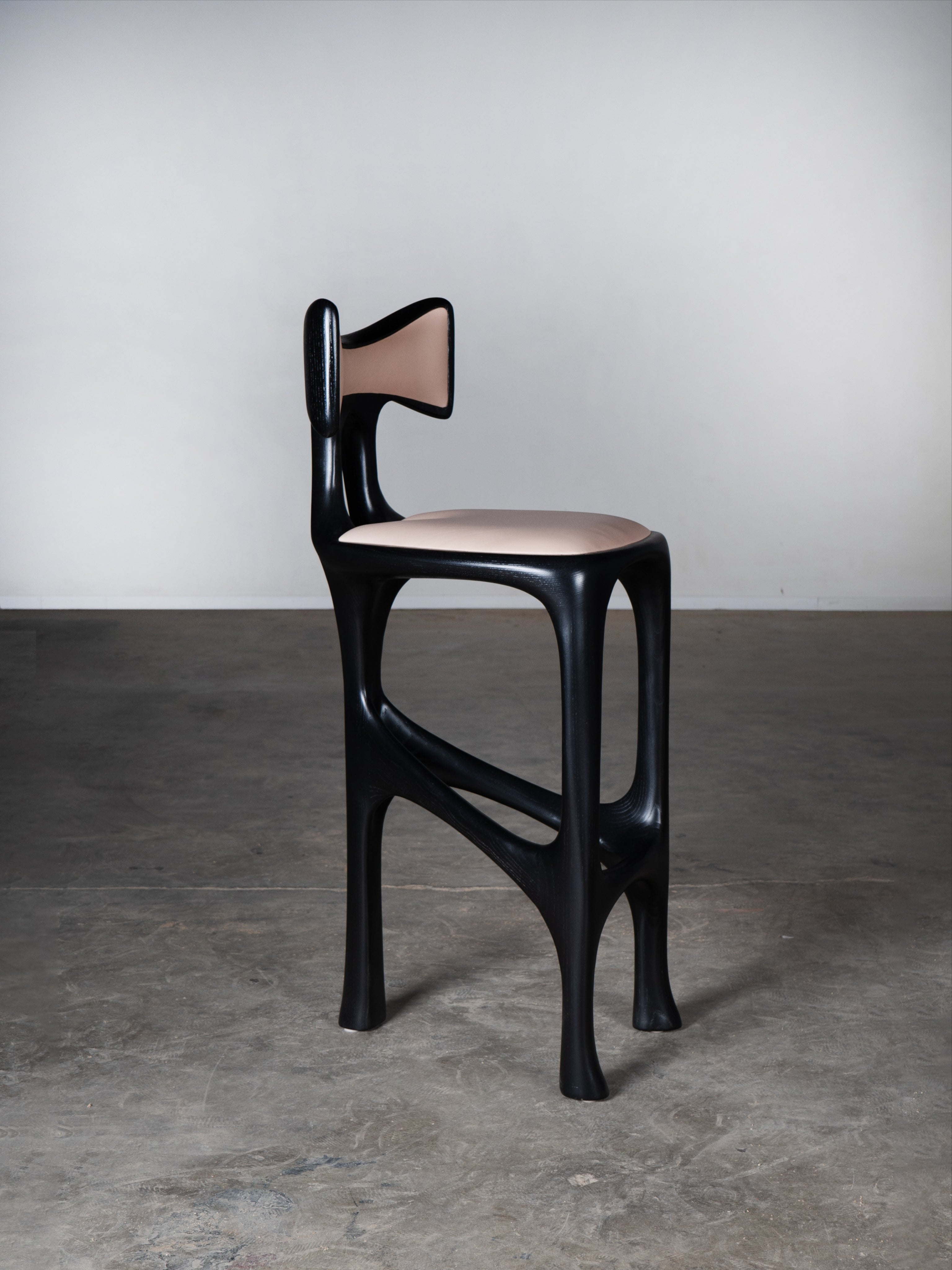 Tripa Stool in Ebony stain on Ash Wood — side view highlighting curved design