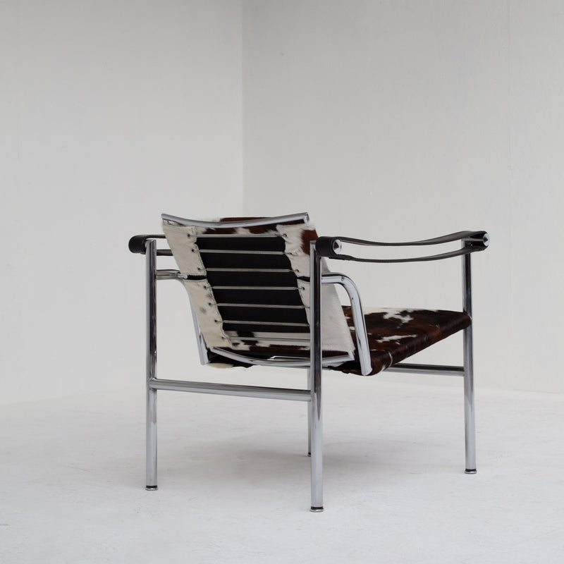 Le Corbusier, Pierre Jeanneret, Charlotte Perriand LC1 Chairs by Cassina — rear view highlighting cowhide seat and chrome fra