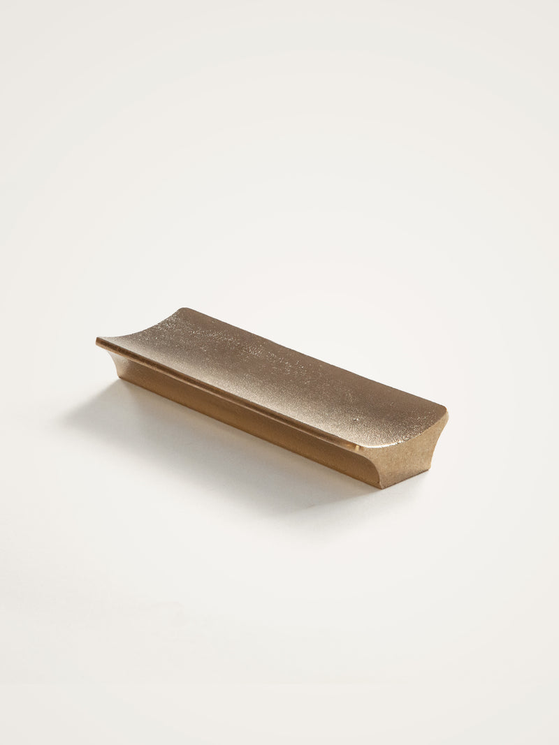 Arc Pen Tray — close-up of textured gold surface