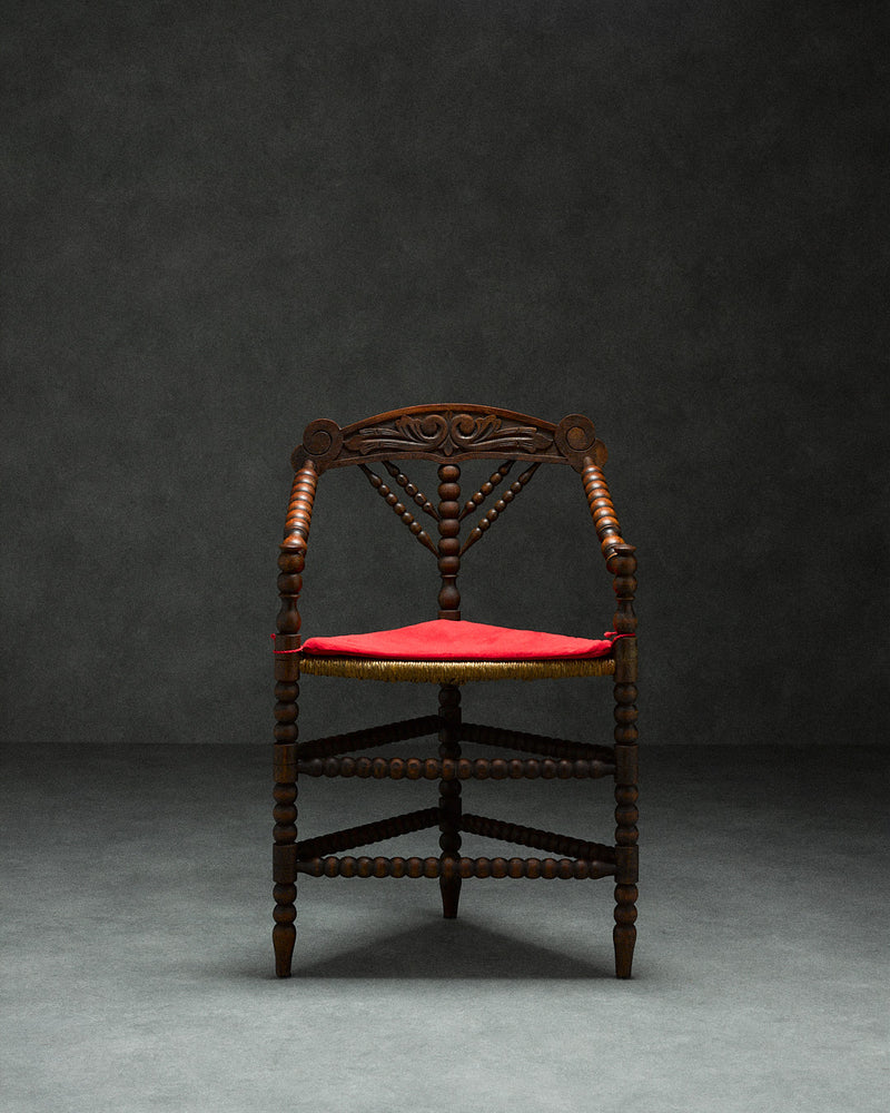 triangular bobbin chair — front view with red upholstered seat