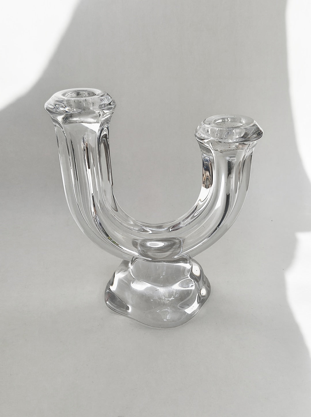 Clear glass arch candle holder with U-shaped design and dual holders