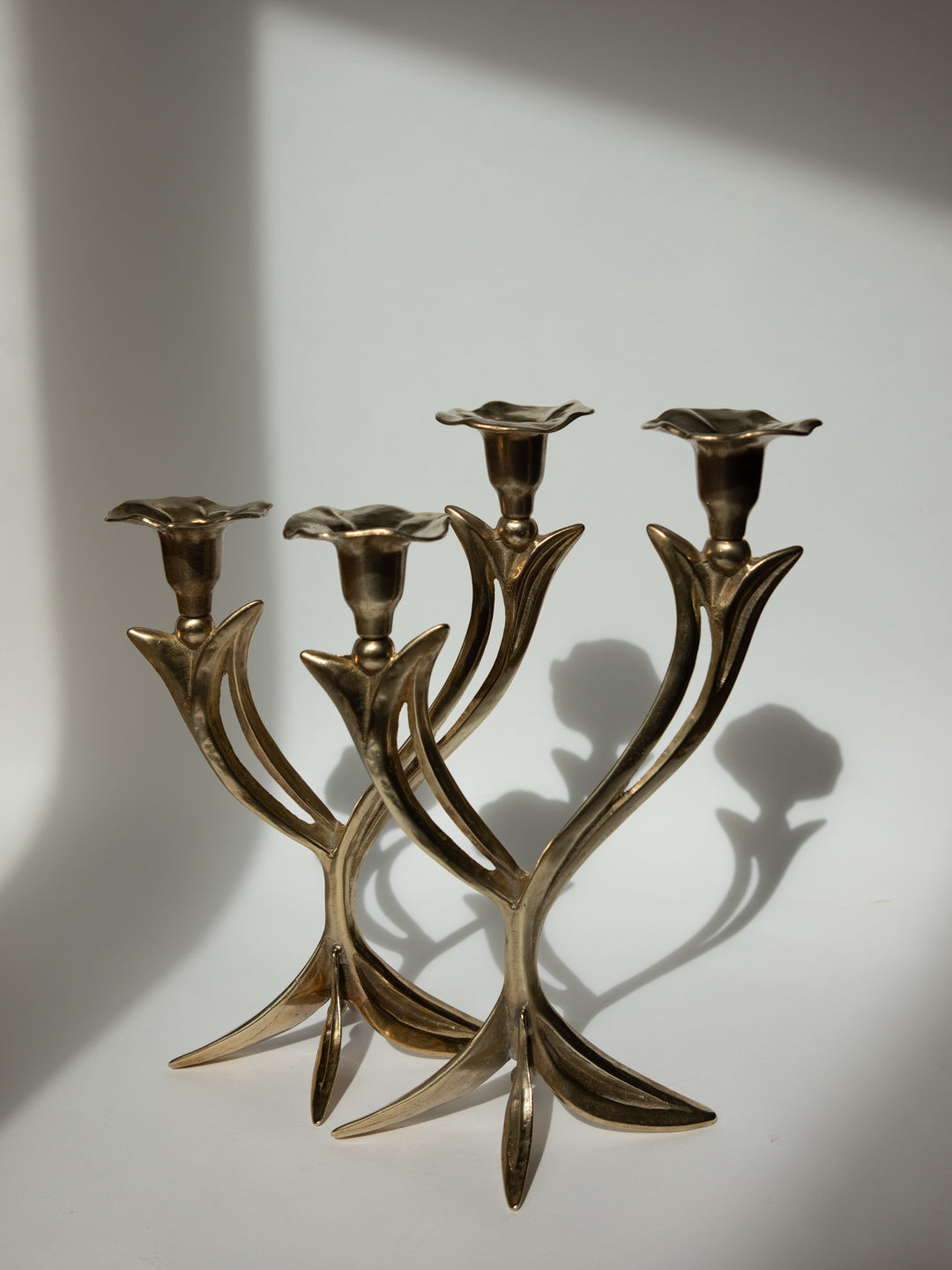 Pair of Sculptural Solid Brass Candlesticks, Floral Form - France, c. 1960s — close-up showing floral-shaped candle holders a