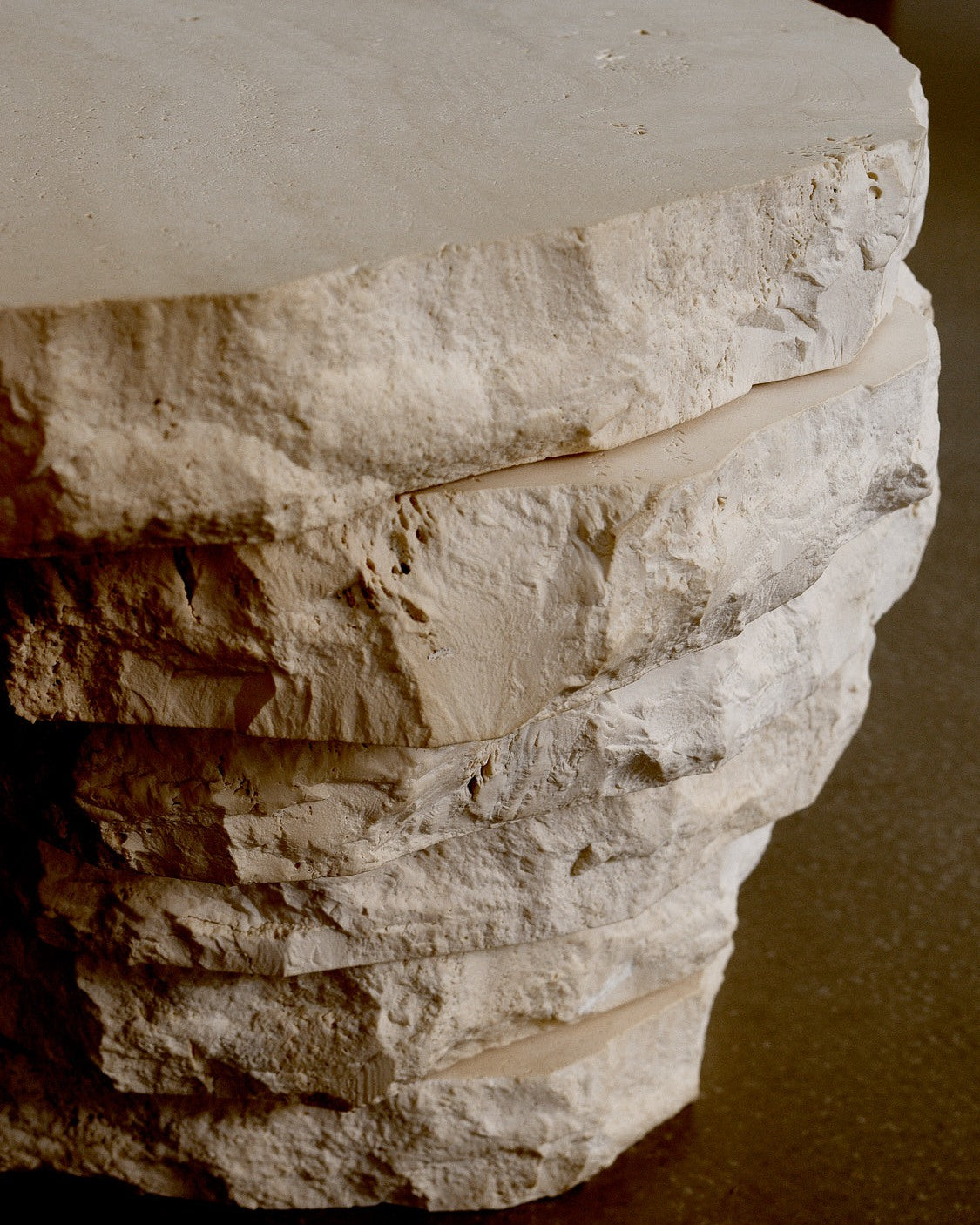 Table in Travertine, Navona by Jesper Sundberg Örtegren — side angle