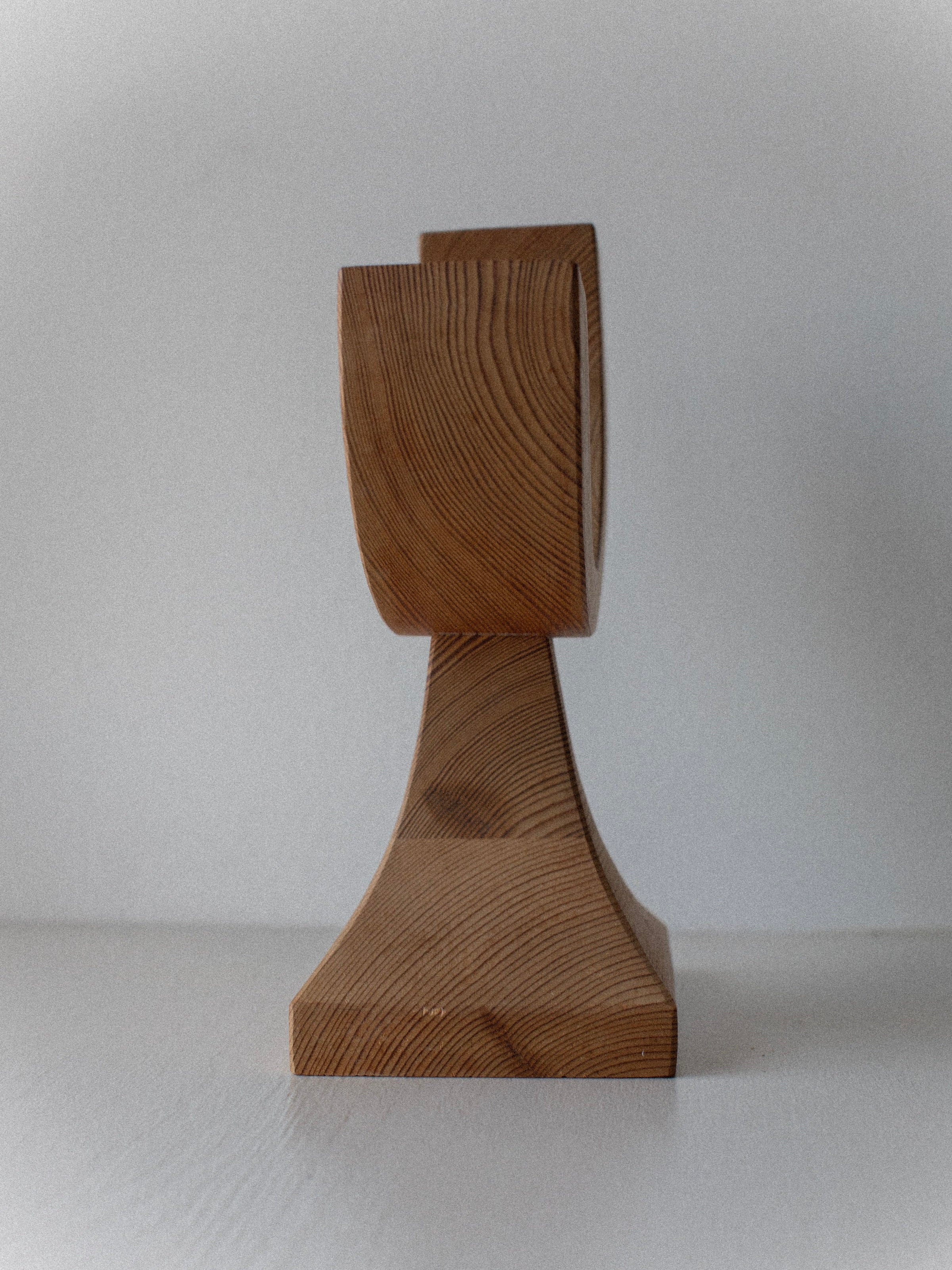 The Out For Lunch Wooden Candleholder, featuring visible grain patterns, stands on a white surface and exudes vintage charm against a plain light background.