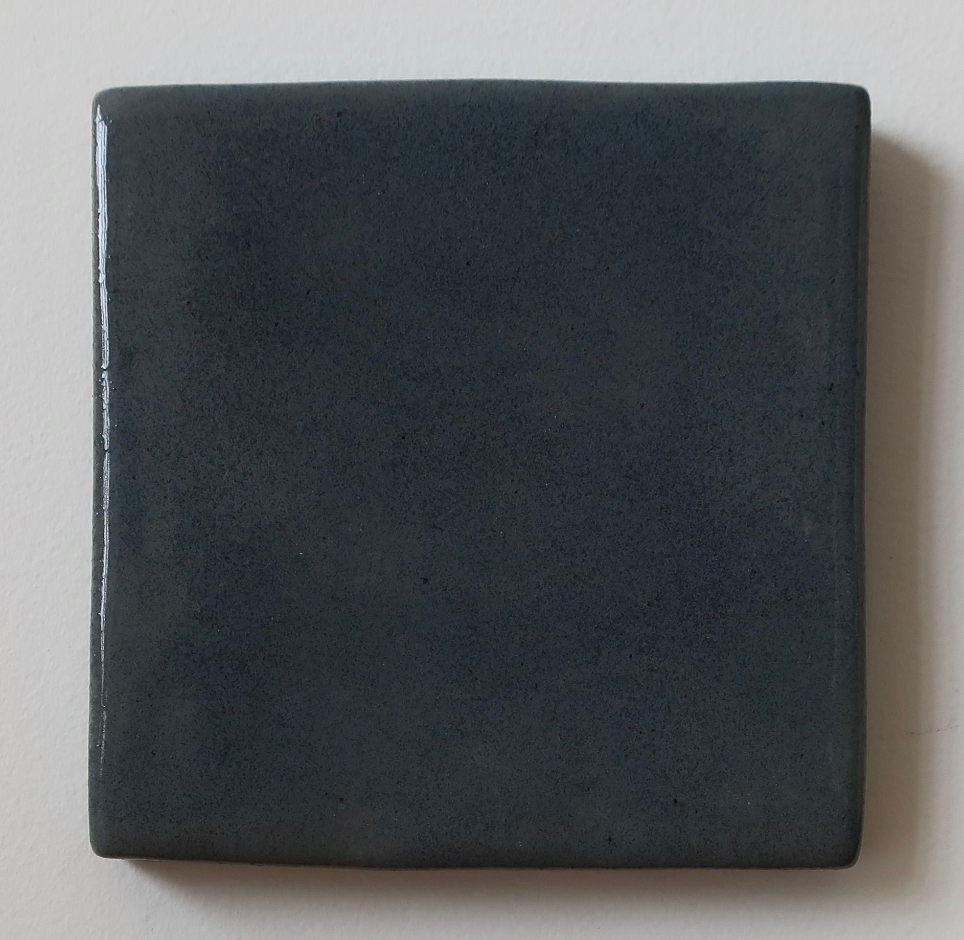 Dark green square ceramic tile with matte finish by ORRE Studio