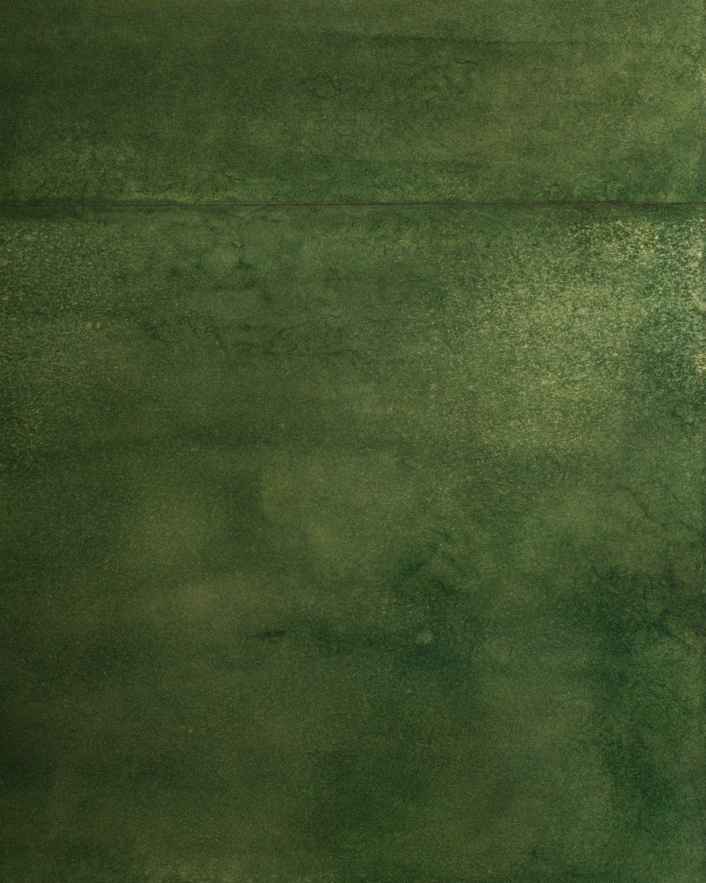 The Green Parchment Table by Galerie Vauvart features a textured green surface inspired by Aldo Tura style, set against a beige pebble-like carpet. The photo captures the bold contrast between the table’s rich hue and the soft beige floor.