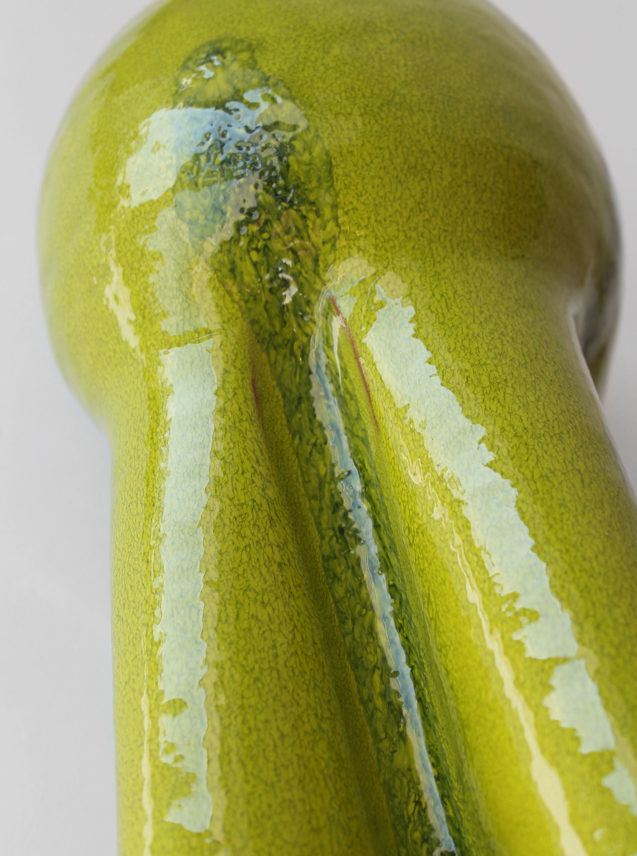 Close-up detail of glossy green ceramic glaze on 70s vase