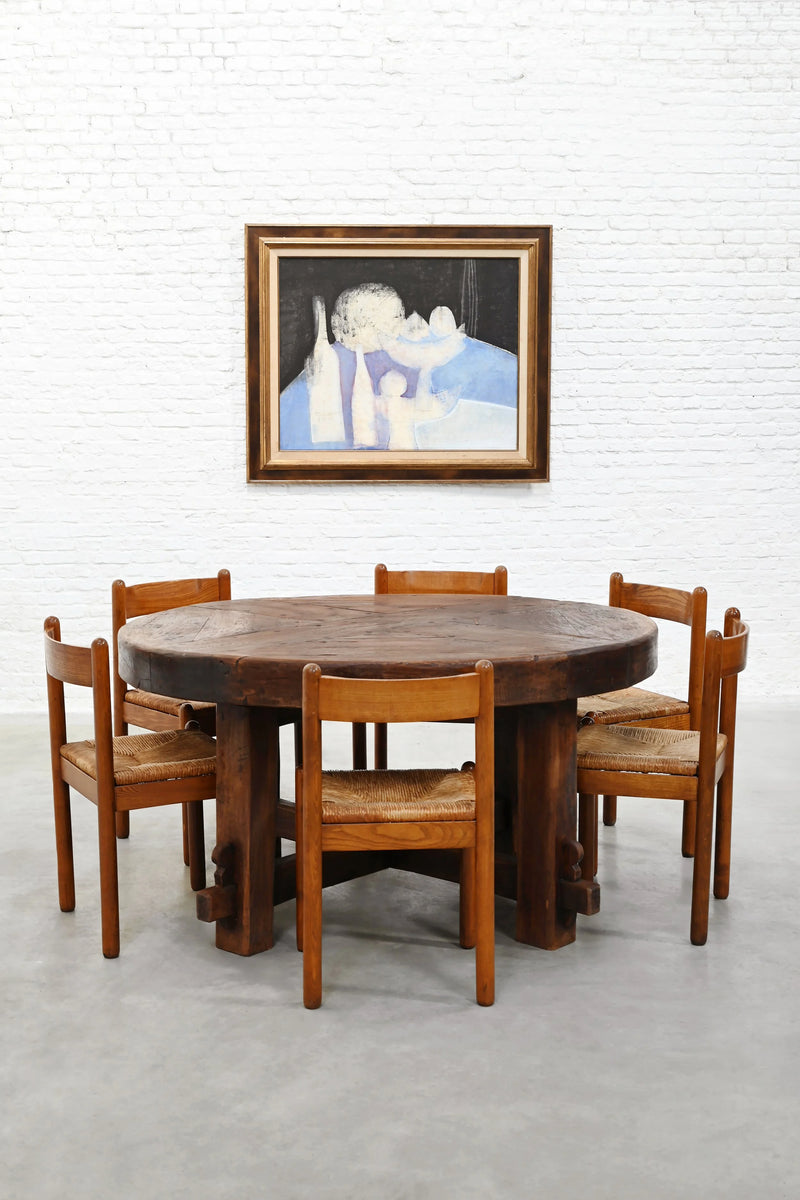 Rustic Wooden Dining Table, France 1920s — round table with woven chairs in gallery setting