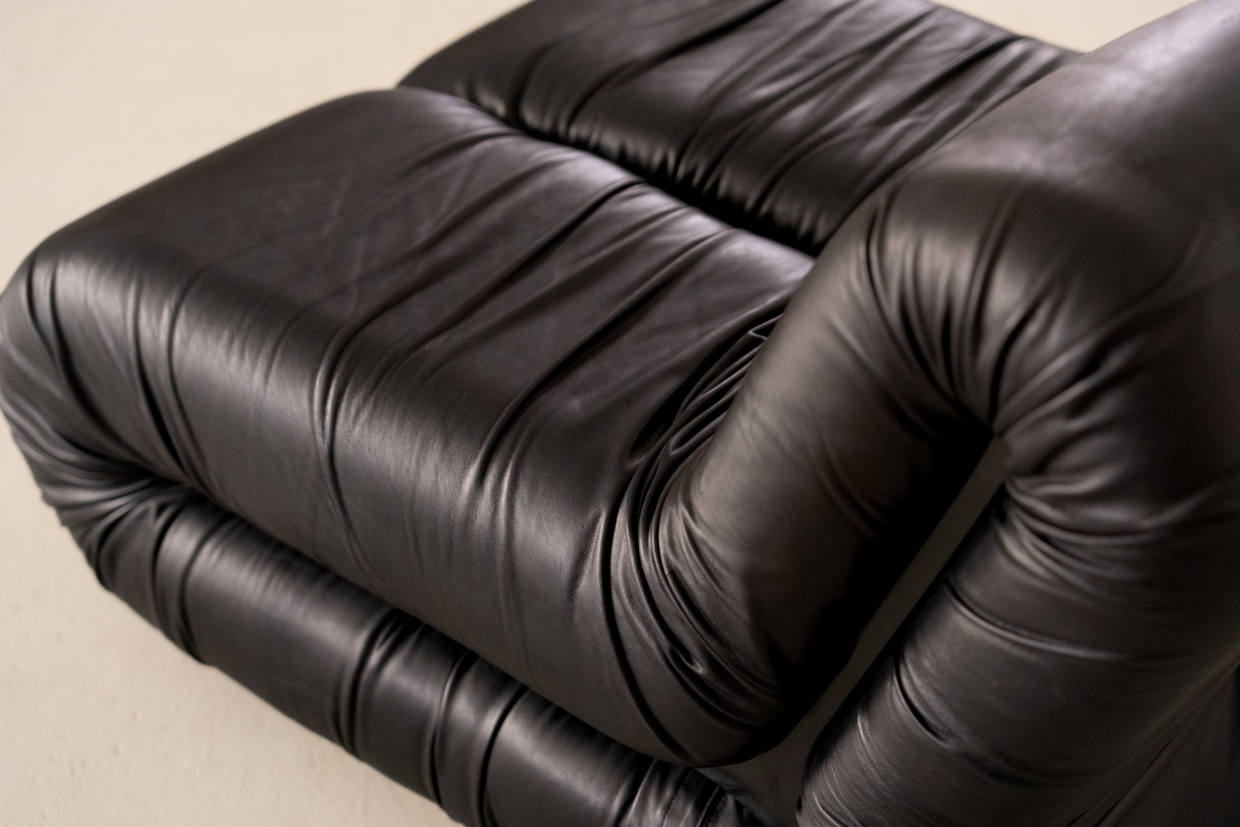 Pagru Lounge Chair by Claudio Vagnoni for 1P — angled view of black leather upholstery