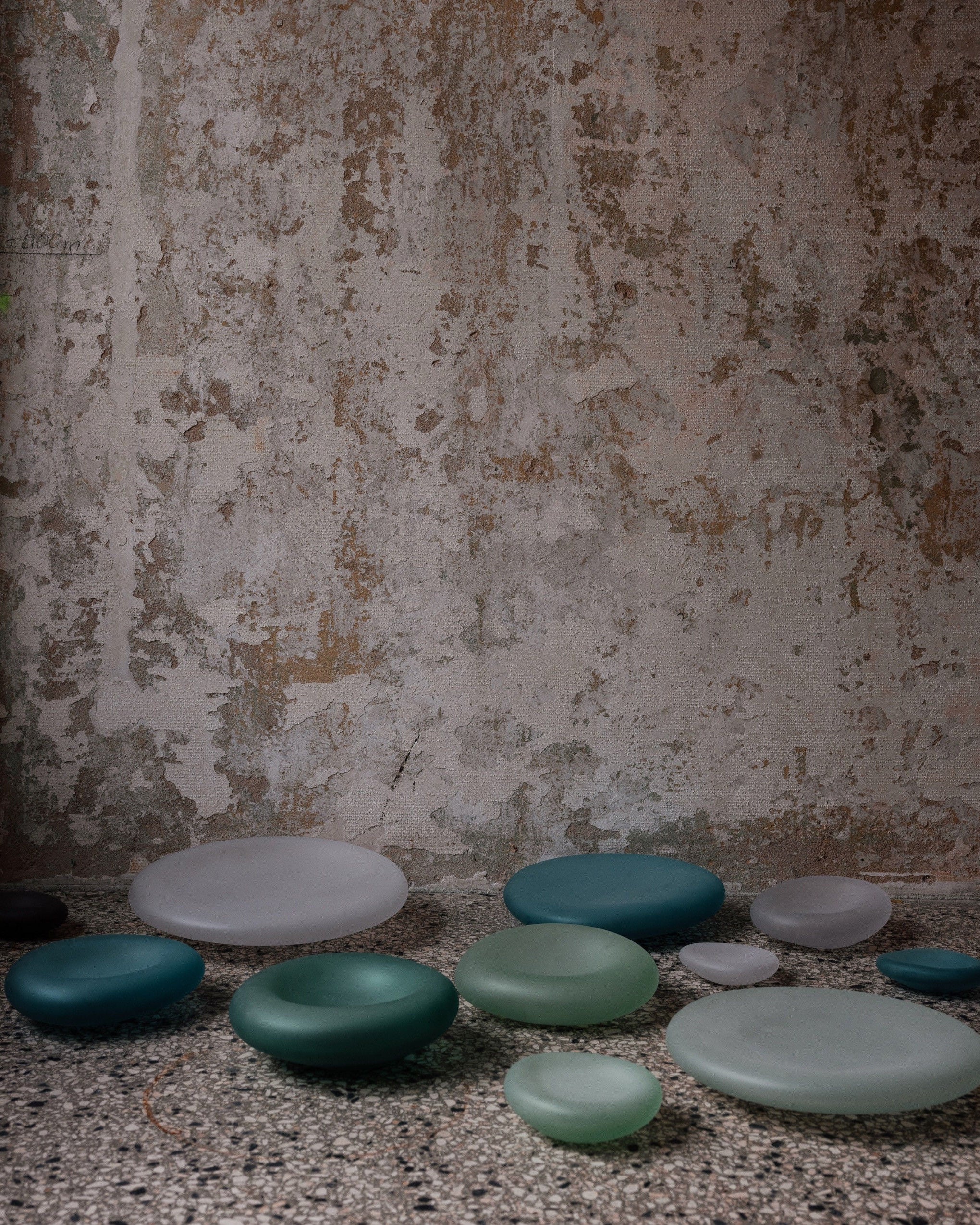 Glass Sculptures SEAGLASS | color teal green — side view on textured surface