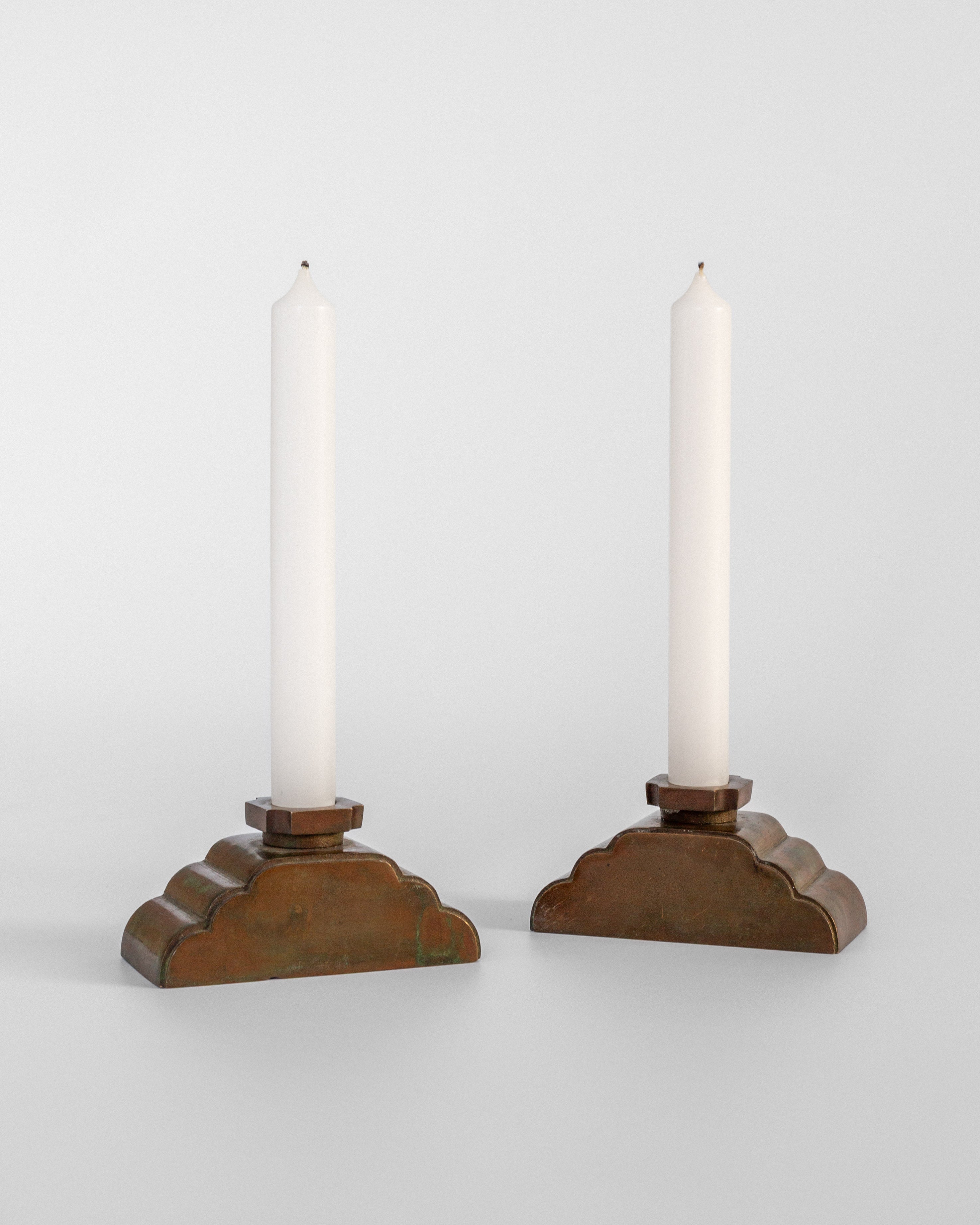 Pair of bronze Art Deco candleholders with white candles, Sweden 1930s