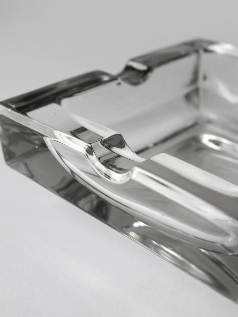 Close-up detail of crystal glass ashtray showing curved edges
