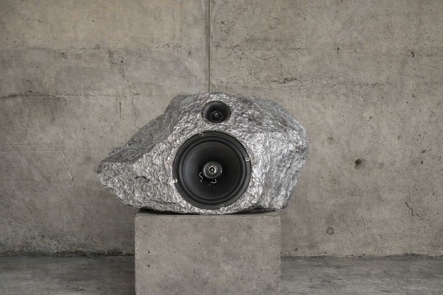 Bronze Singing-Stone MDL. C. Speaker — textured stone finish on concrete pedestal