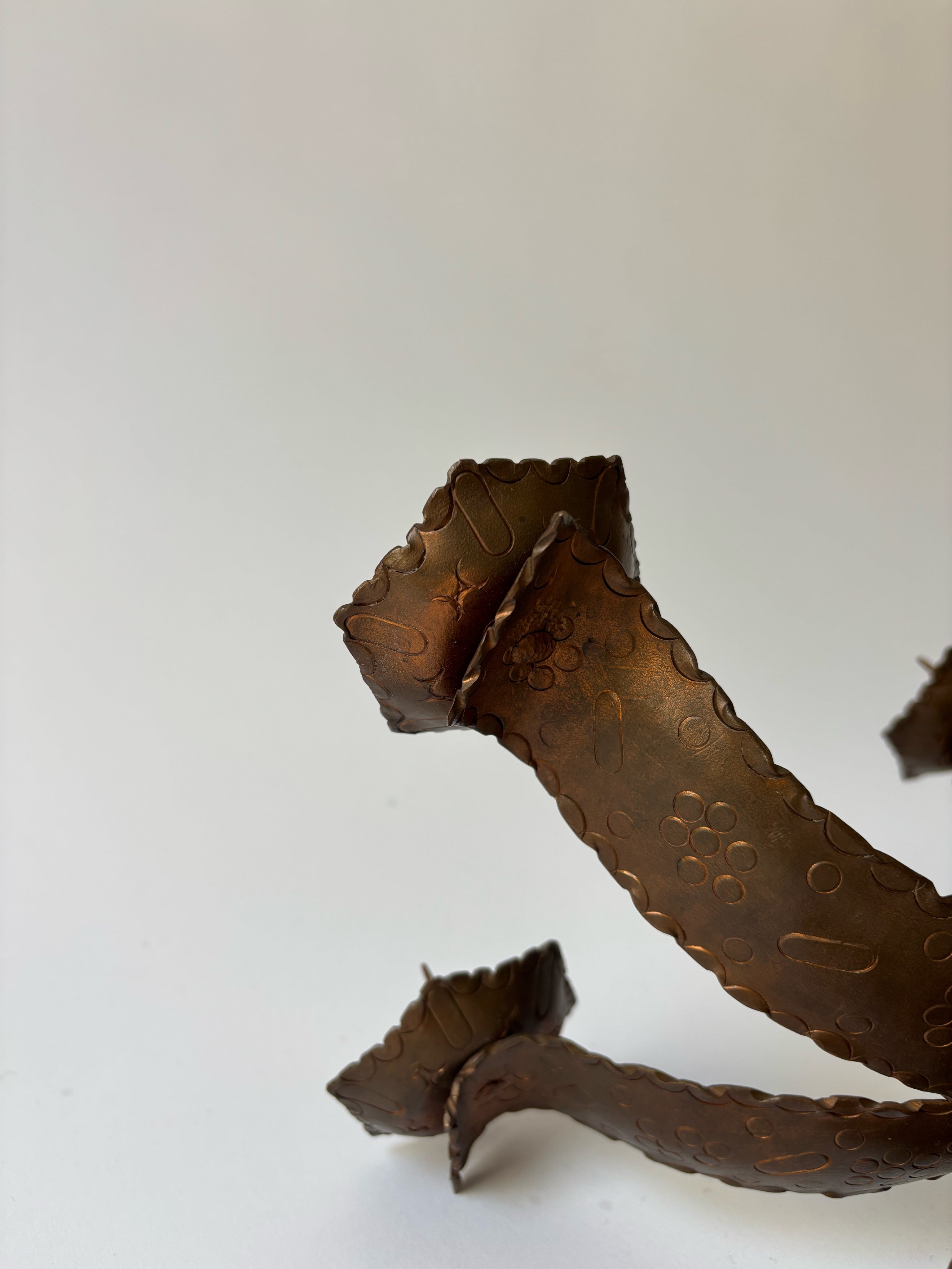 Large Metal Curved Artisan Candlestick, Poland — side angle showing textured bronze finish