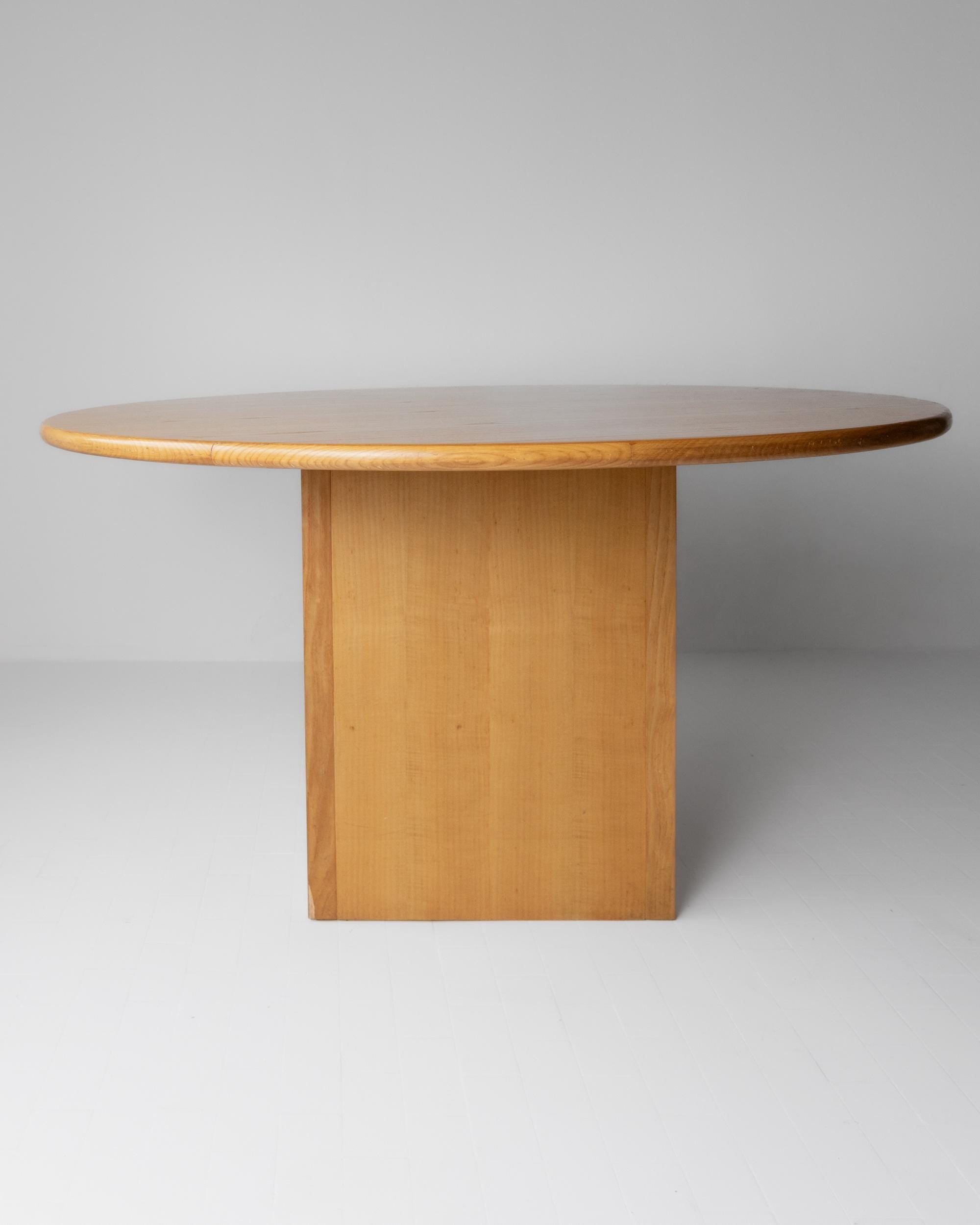 1980s Large Round Wooden Table — side view of light wood finish
