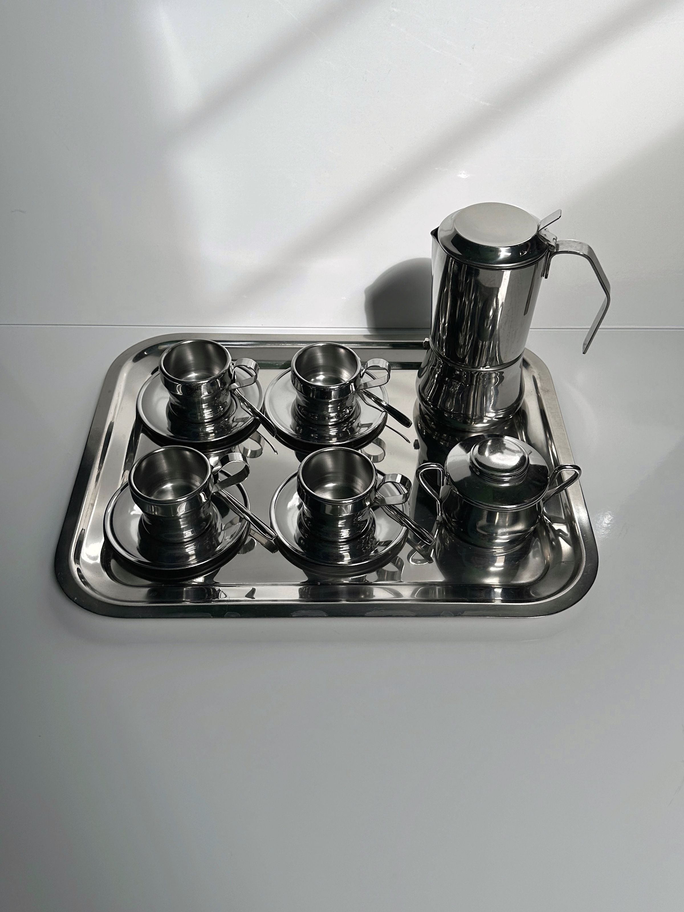 Italian Stainless Steel Coffee Set for 12 Persons — top view on reflective surface