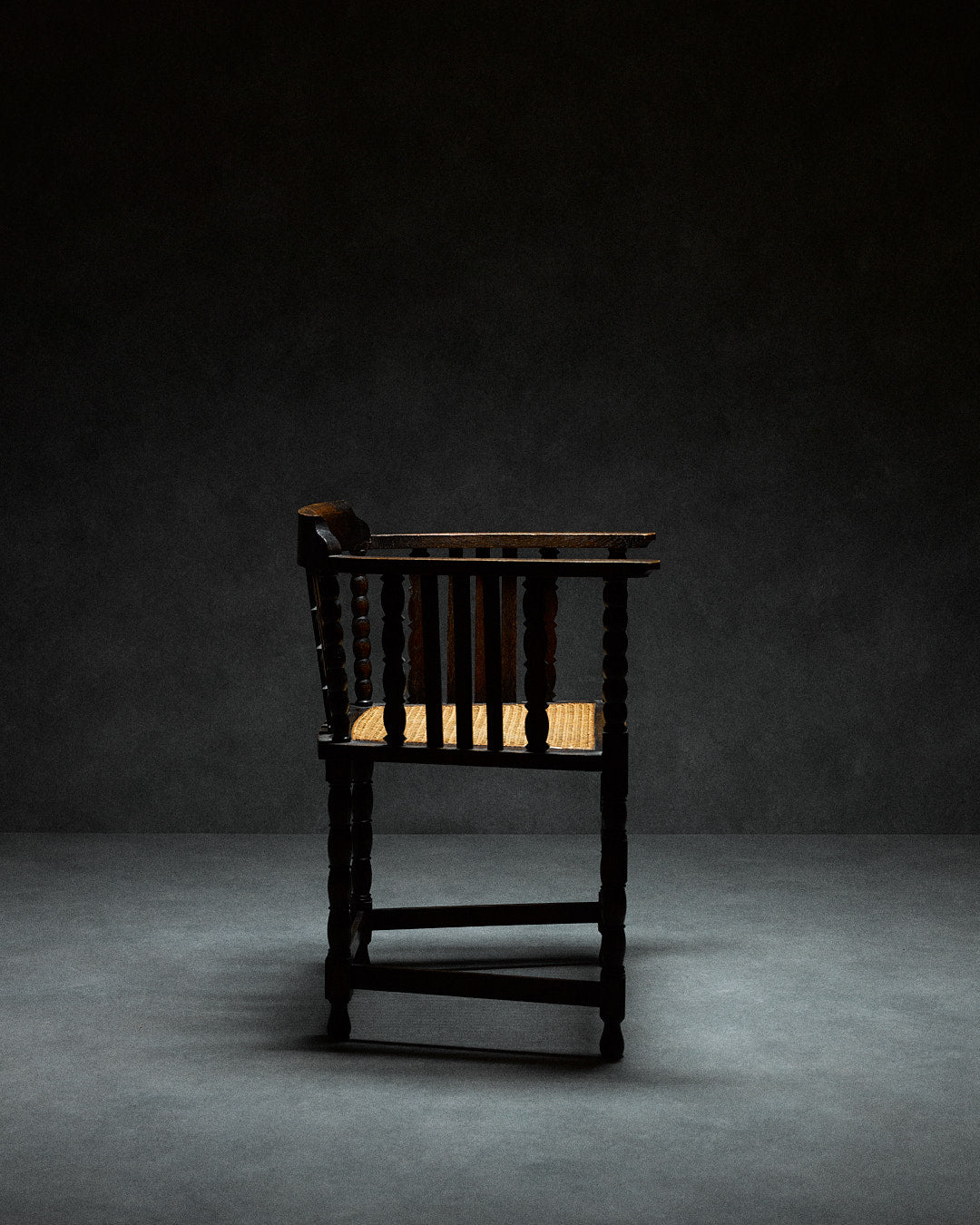 Captains Chair with Cane Seating — back view highlighting dark wood frame