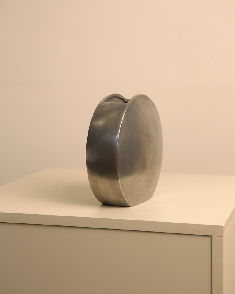 Italian cast aluminum vase profile view showing curved sculptural form